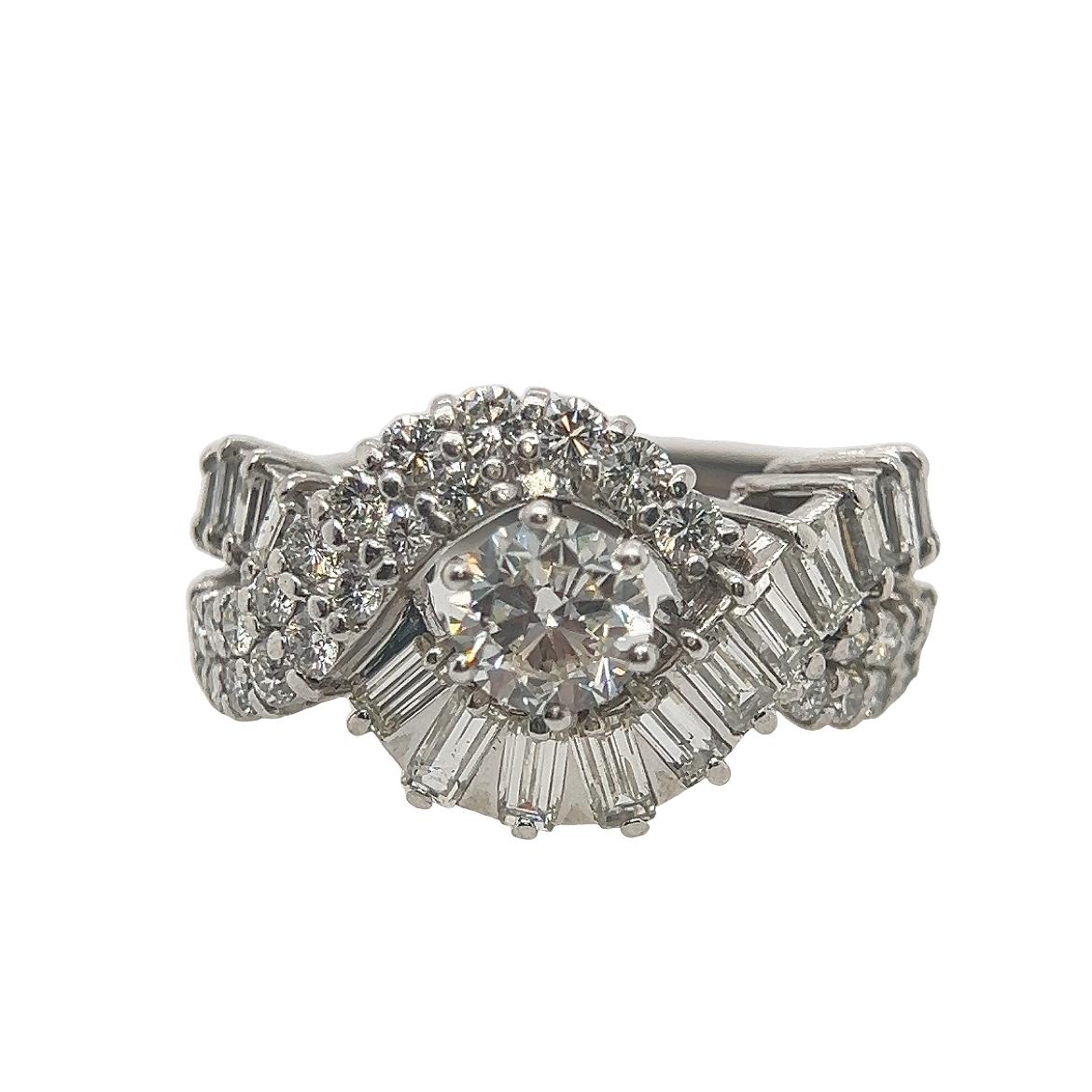 An exquisite mixed cut diamond cocktail ring. 

The central stone is approximately 1ct and is a brilliant cut diamond. 

Surrounding diamonds are approximately 1.5cts and are brilliant and baguette cut diamonds. 

Set in 18ct gold. 