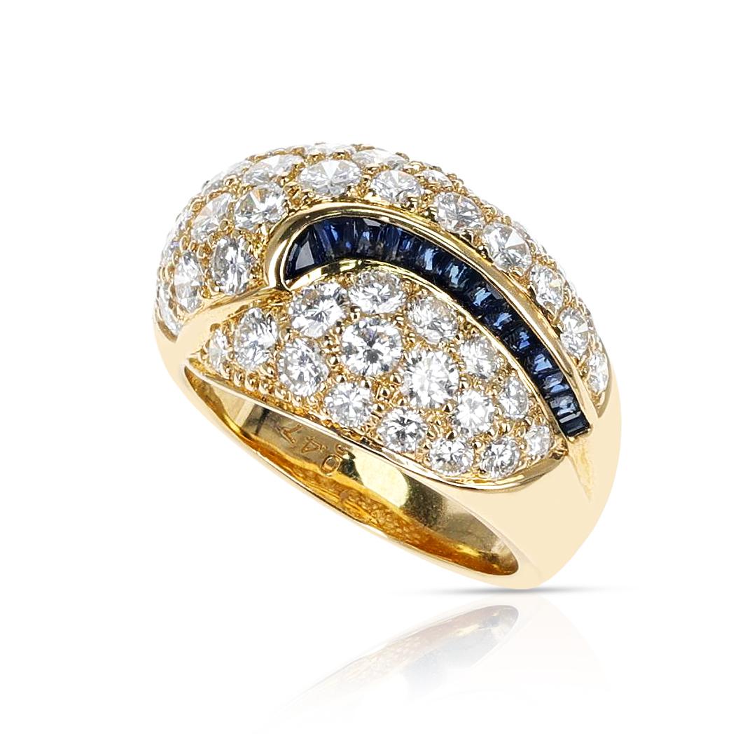 A Diamond Cocktail Ring with Sapphire Square Cut Swerve made in 18 Karat Yellow Gold.  The Diamonds are appx. 3.60 carats and the sapphires are appx. 0.47 carats. The Ring Size is US 6.25. 


