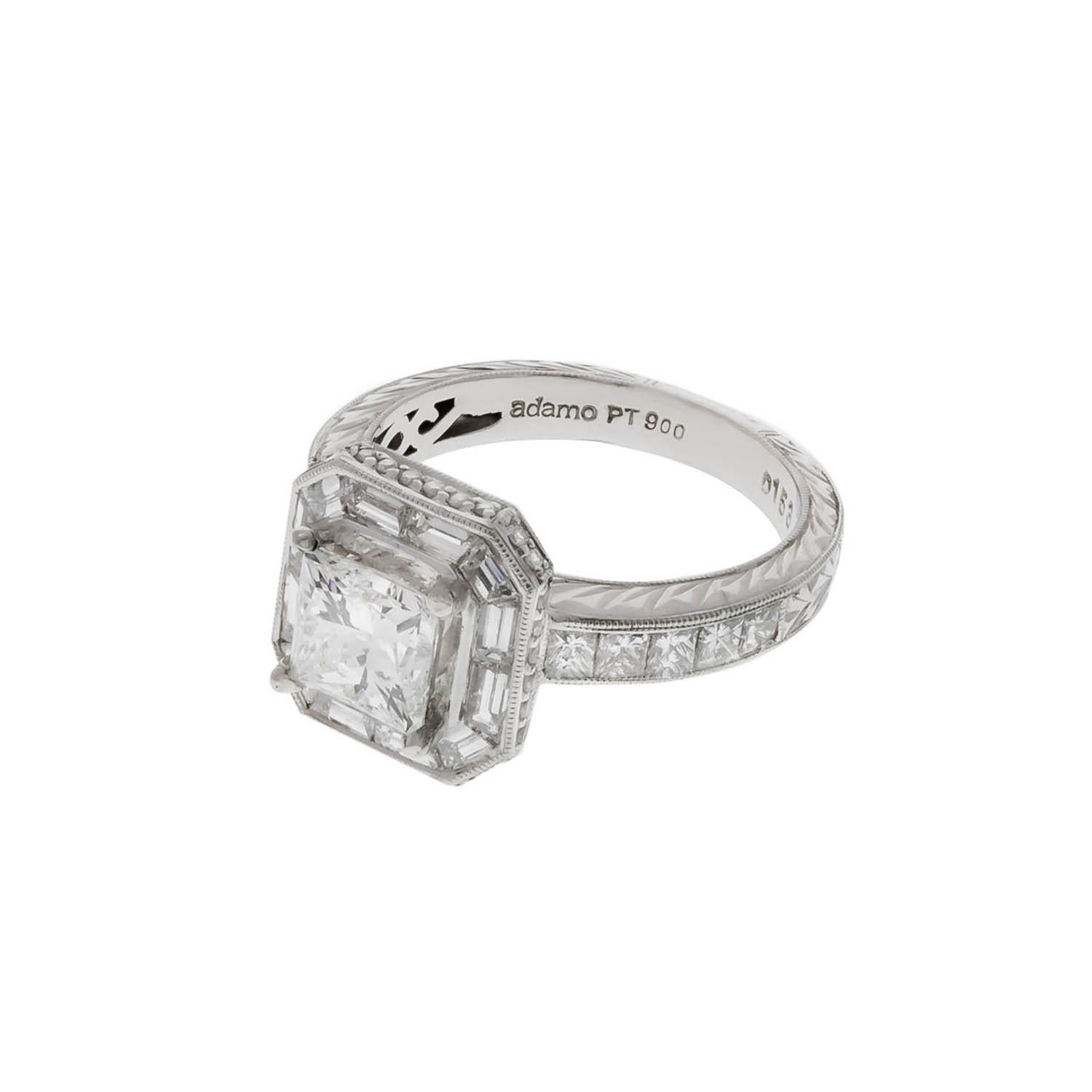 Platinum ring containing as a center stone a 1.57 carats Princess cut diamond  E color, VS2 clarity. The center diamond is surround by a bezel containing baguette and round diamonds. The shank is engraved and contains 10 princess cut diamonds.
Size