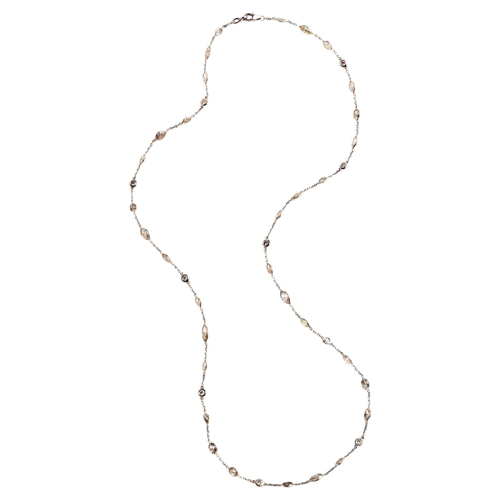 This delicate 14k white gold neck chain is set with approximately 10 carats of alternating round, oval, marquise and pear-shaped diamonds. The diamond facets catch the light as the necklace moves on the body.

25” in length 
43 diamonds weighing