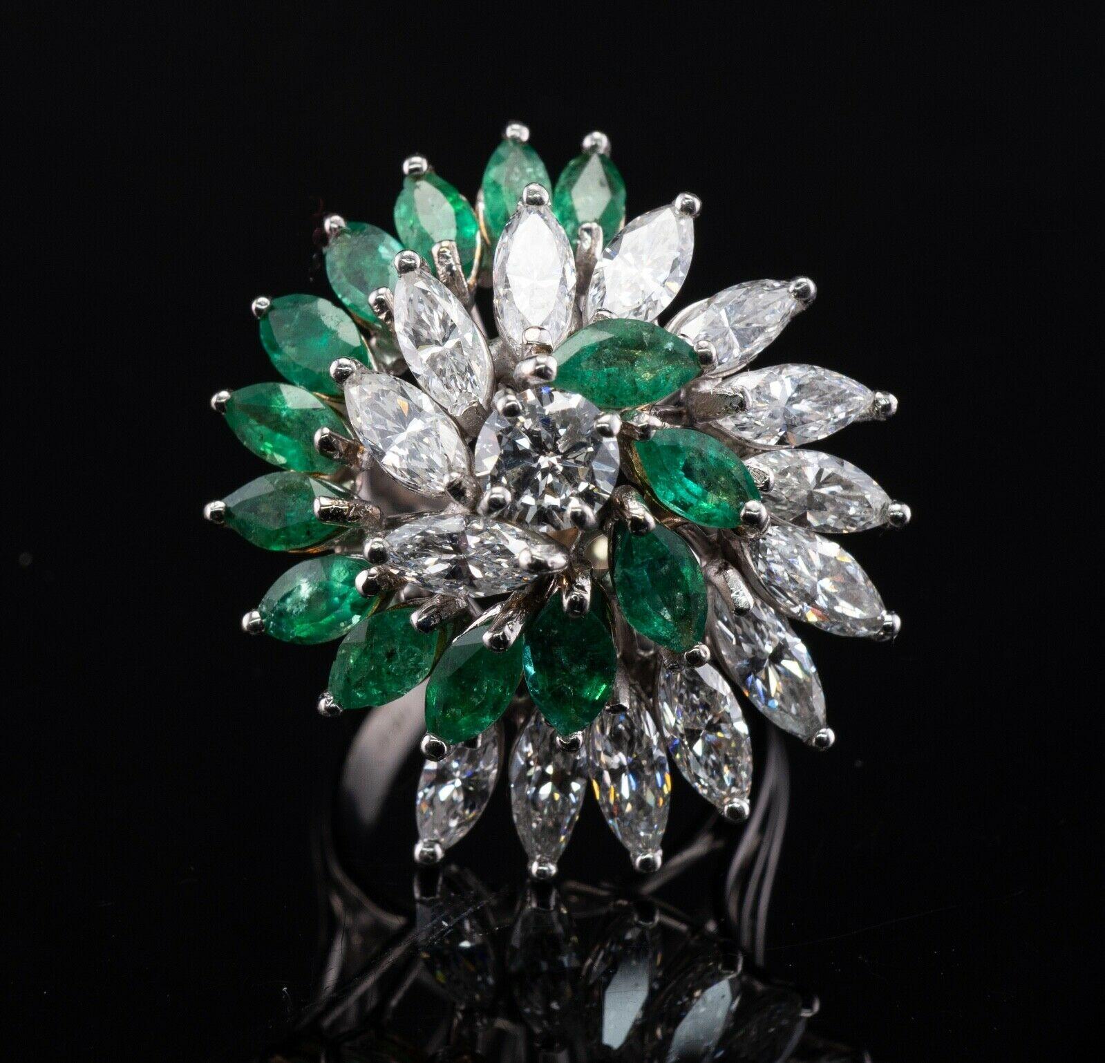 This vintage circa 1970s ring is crafted in solid 18K White Gold. 14 marquise cut natural Emeralds measure 6x3mm each = 3.36 carats. These gems are in very good vintage condition, some have minor signs of wear that cannot be seen without