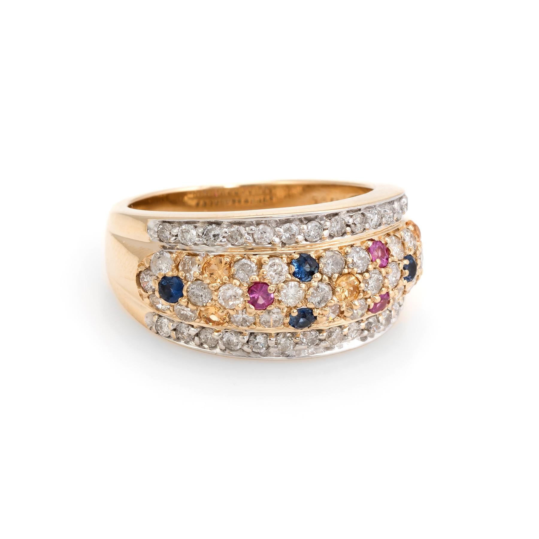 Striking vintage band, crafted in 14 karat yellow gold. 

Diamonds are pave set into the mount and total an estimated 0.76 carats (estimated at H-I color and SI1-I1 clarity). The colored sapphires (pink, blue and yellow) total an estimated 0.20
