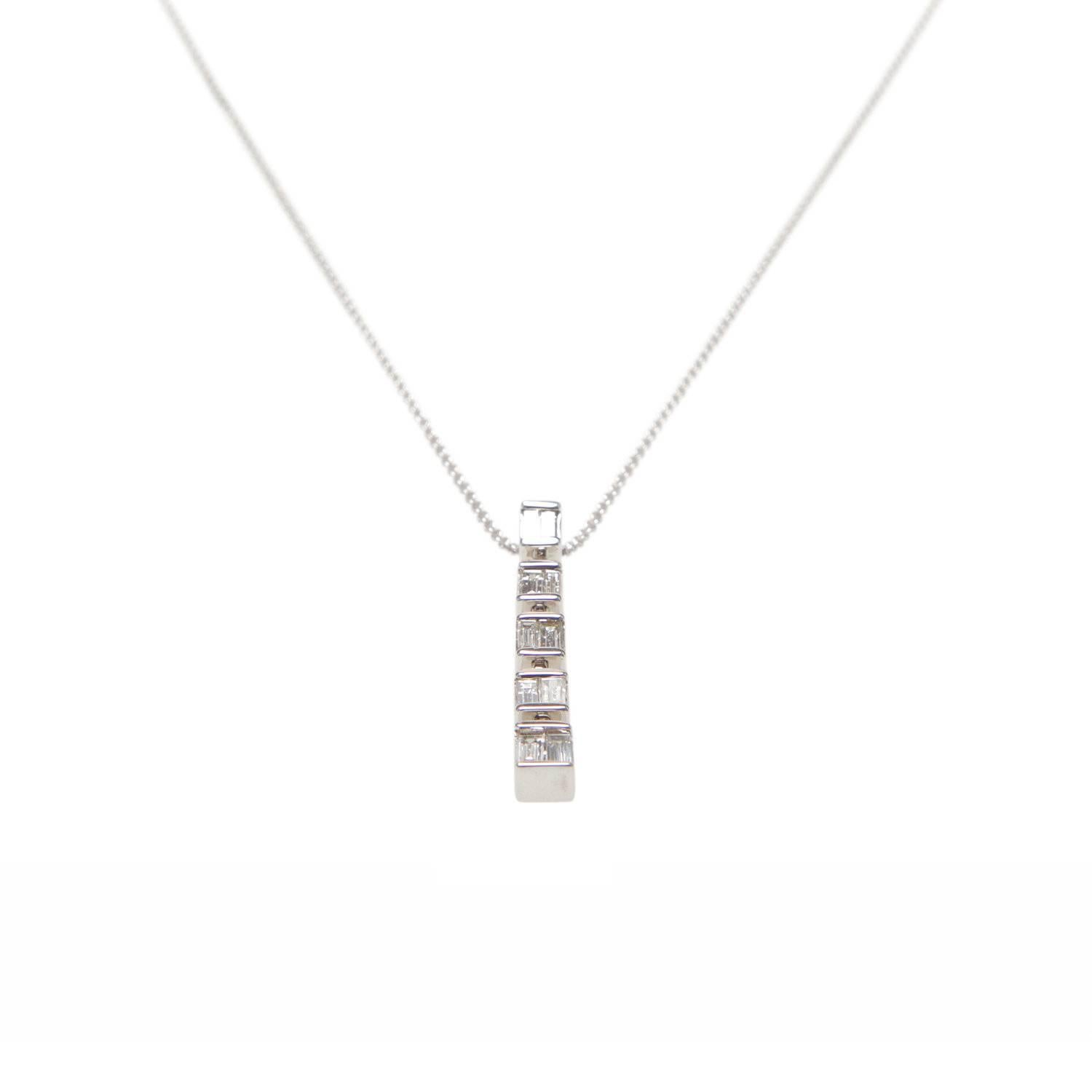 Vertical diamond baguette row pendant necklace in 14k white gold. 
200mm chain length with 4mm wide x 29mm high pendant.

