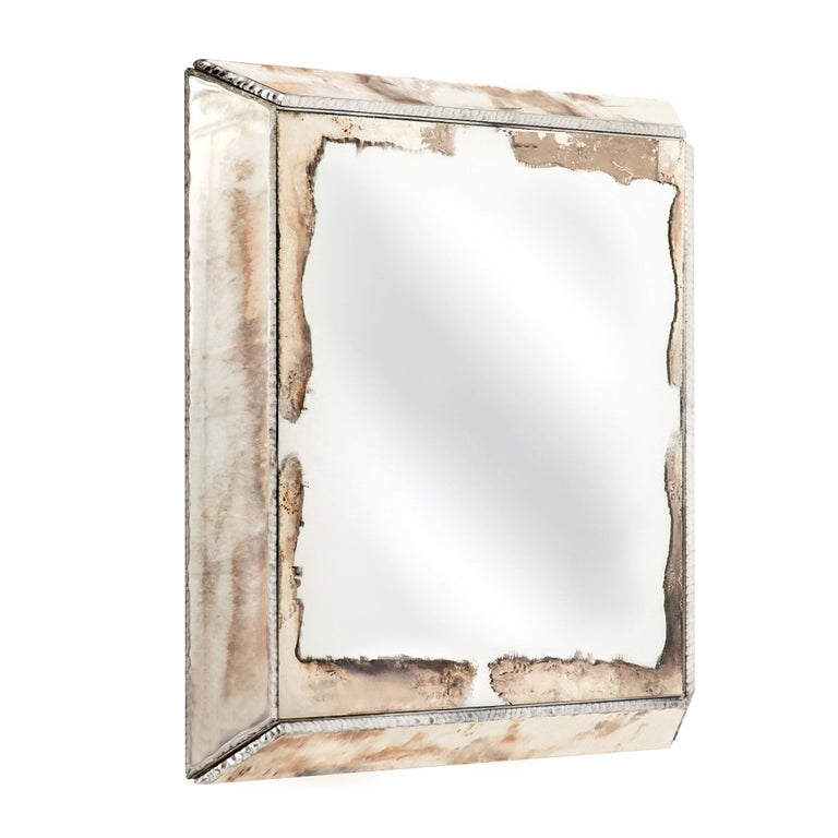 This mirror is a contemporary sculpture art piece, made entirely by hand in Tuscany Italy, 100% of Italian origin. 
 
The body, handmade of multilayer wood, has a threedimensional shape.
At its center there is a real mirror, the silvered hammered