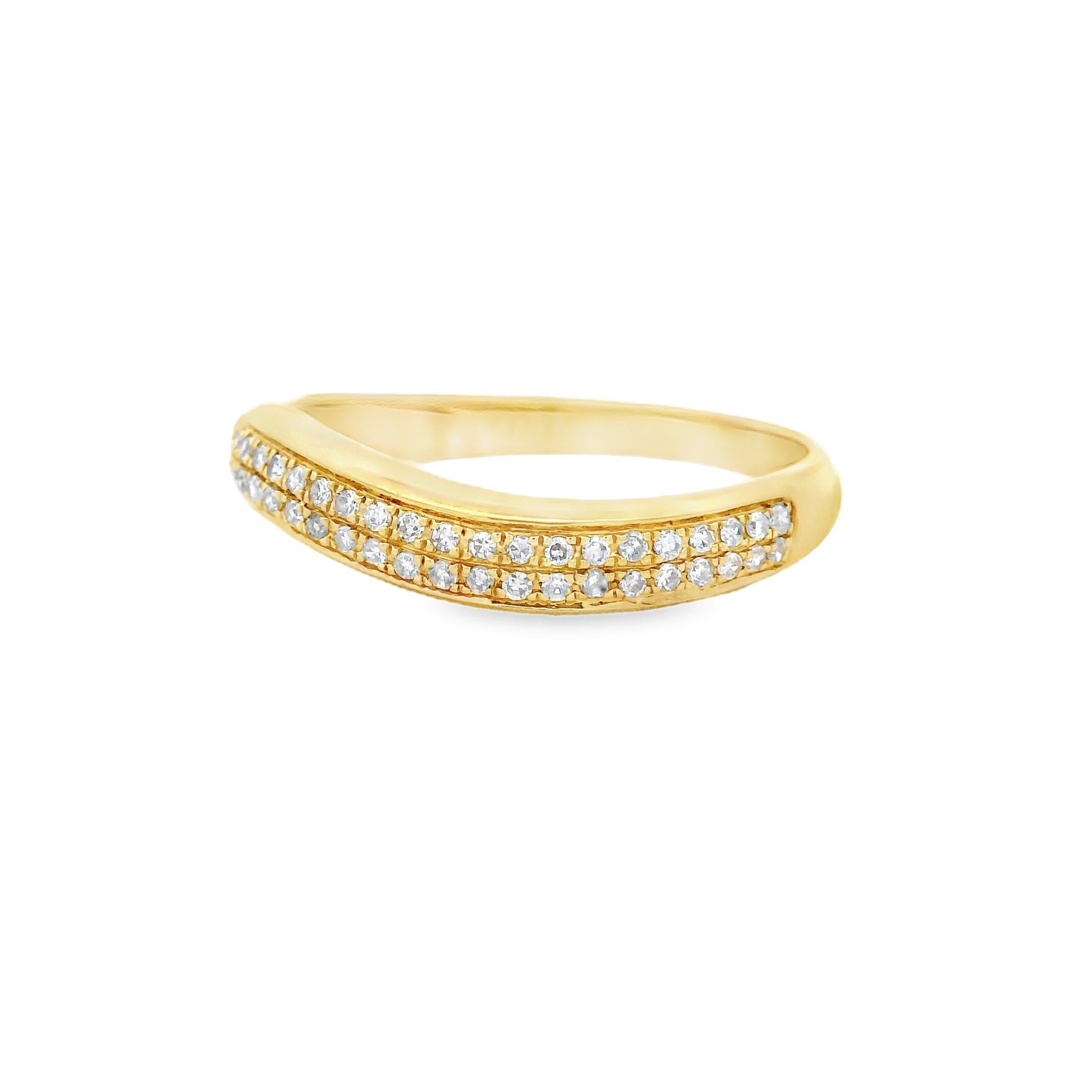 This delicate and modern contour band ring is crafted in 14-karat yellow gold and features 54 round brilliant-cut diamonds in a double-row pavé setting. The soft wave silhouette is designed to hug the curve of an engagement ring or stand alone with