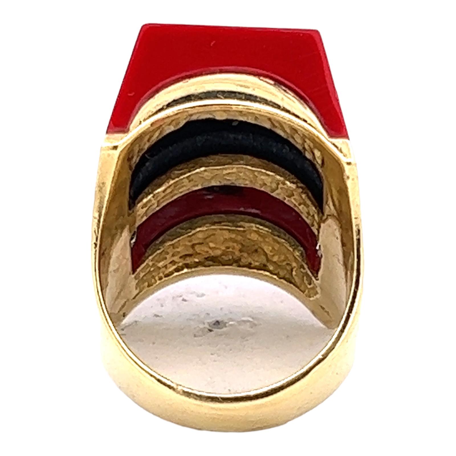 Fabulous diamond, coral, and onyx cocktail ring handcrafted in 18 karat yellow gold. The ring features modern straight cuts of coral and onyx gemstone separated by 20 round brilliant cut diamonds weighing approximately 1.60 CTW and graded G-H color