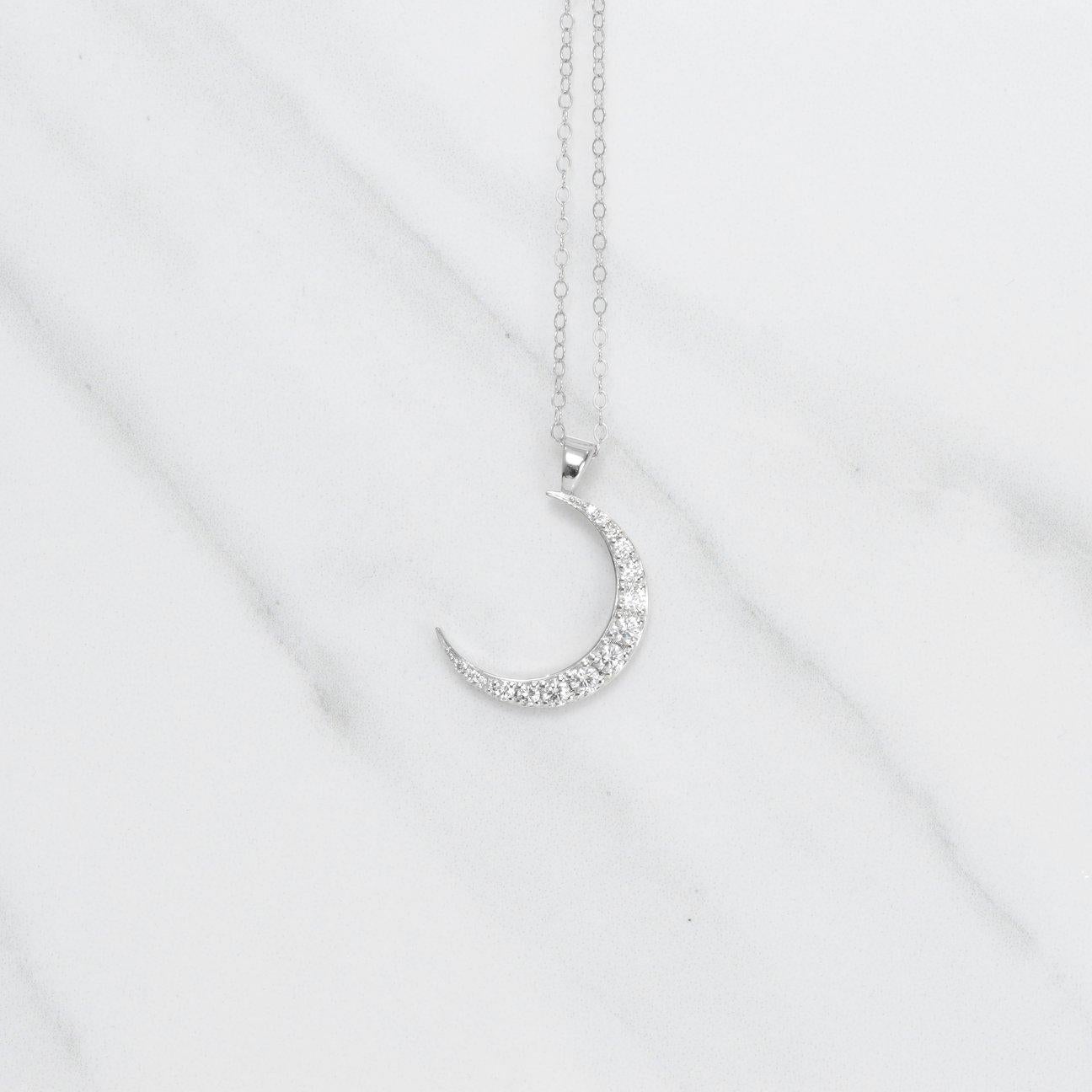 A pendant that truly glistens! This stunning diamond crescent moon pendant necklace is filled with .49 carats of beautiful diamonds, that are all set in 14k white gold. The moon pendant measures 25mm in length.