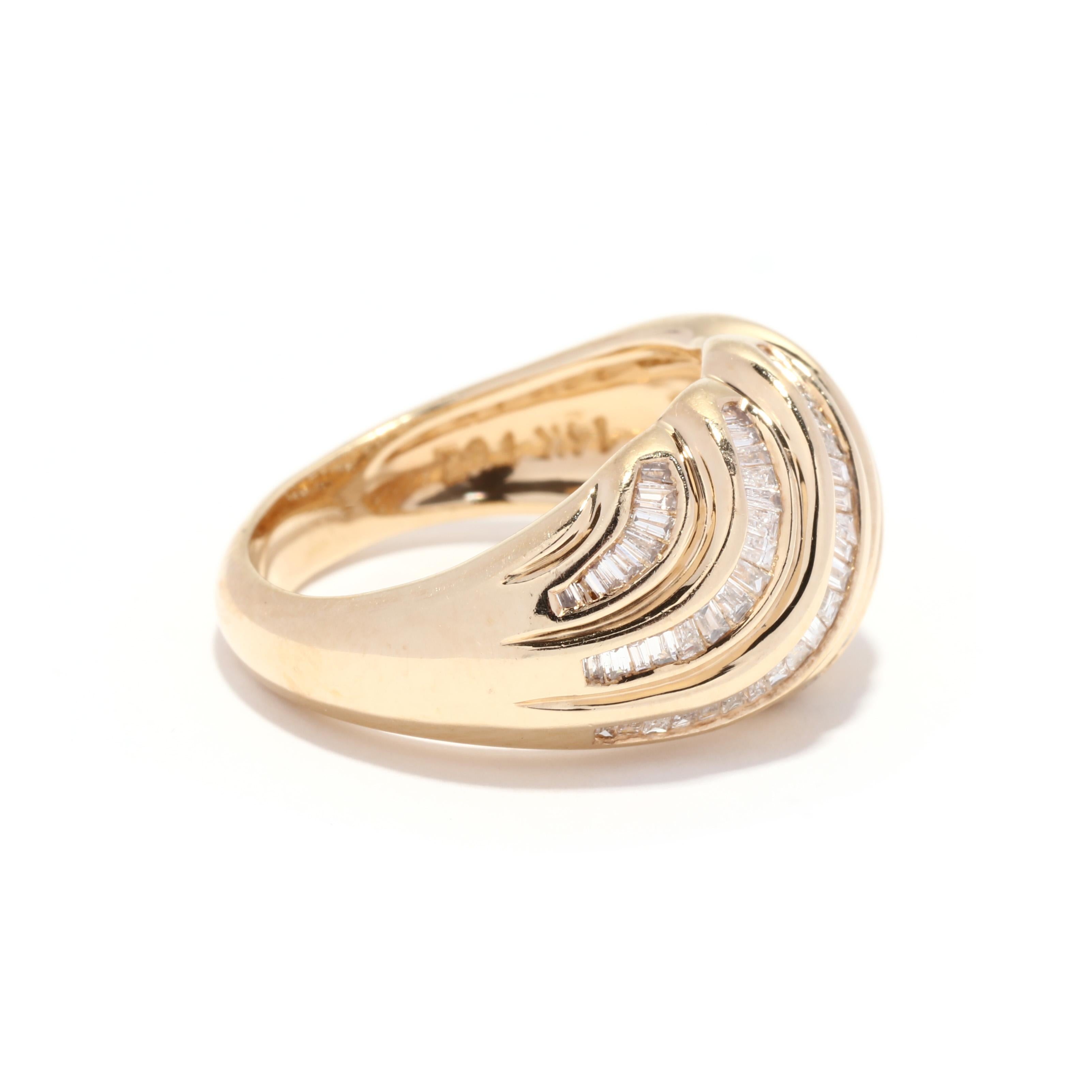 A vintage 14 karat yellow gold diamond croissant ring. This ring features a ribbed dome design with full cut round diamonds weighing approximately .38 total carats and baguette cut diamonds weighing approximately .66 total carats and with tapered