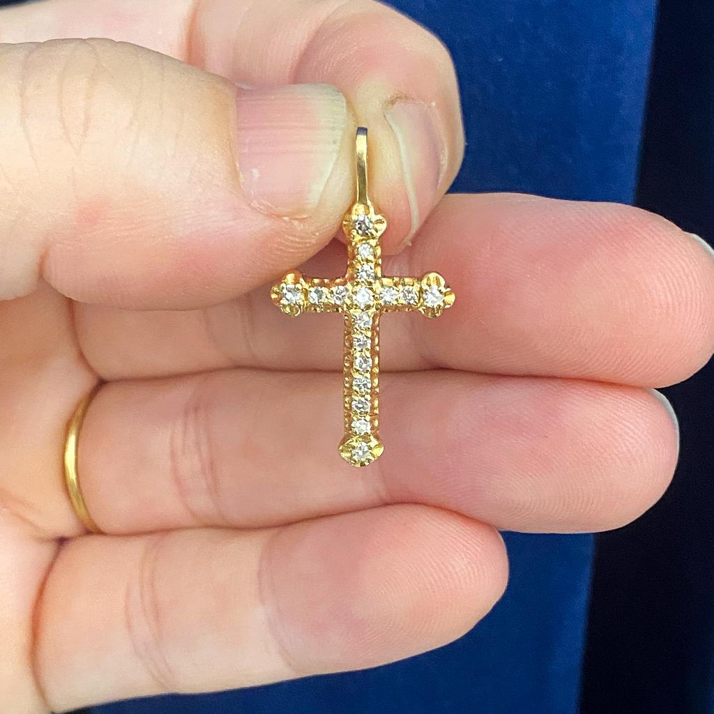 This sparkling diamond cross is perfect for the person whose spirit shines just as bright! Round diamonds line the cross, catching the light and showing the fire hidden within the light. The diamonds weigh a total of 0.10 carats. The rounded ends of