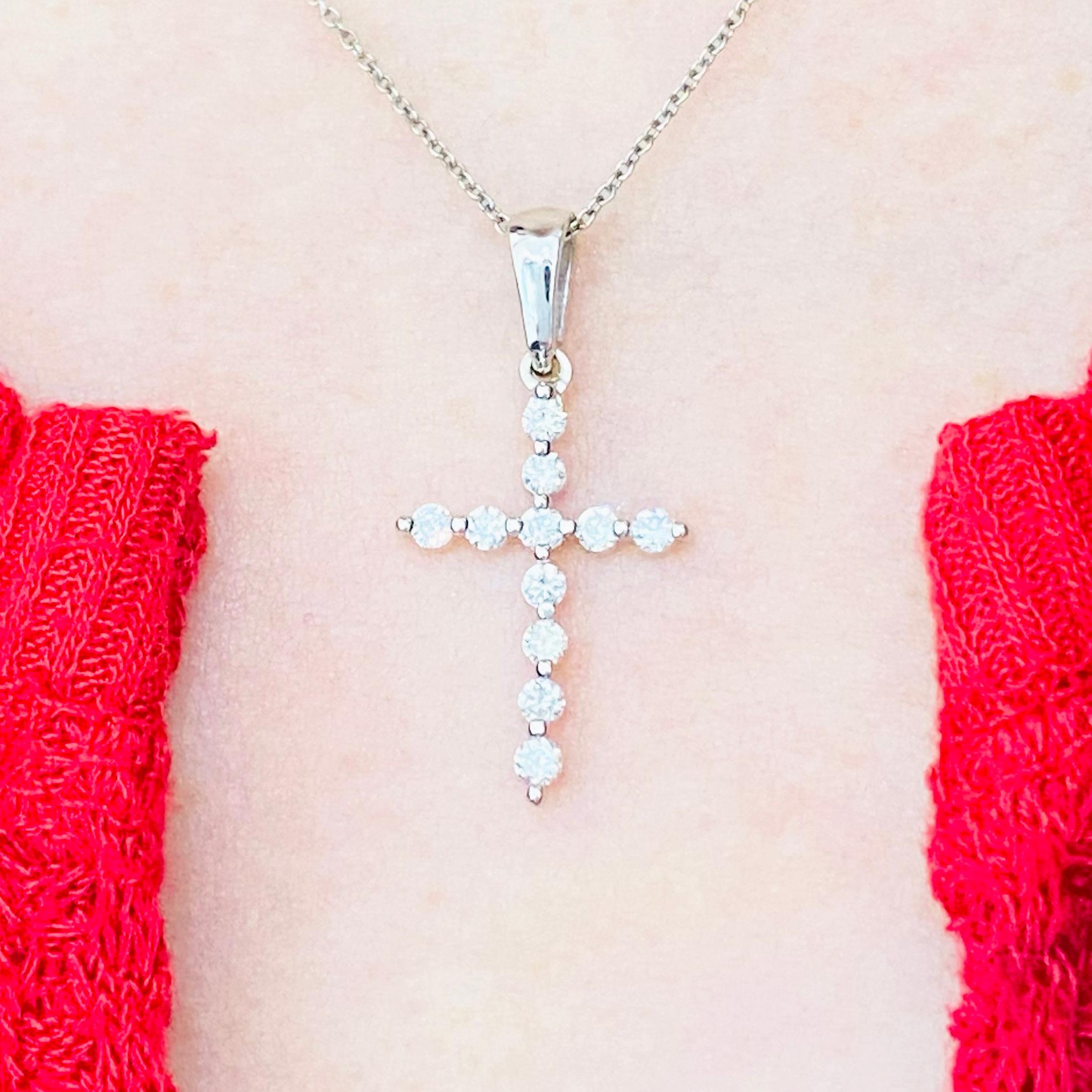 This gorgeous, delicate diamond cross pendant is a stunning and striking design. The cross pendant is made in 14 karat white gold with genuine, natural diamonds. This pendant is on an 16 inch cable chain that compliments the cross pendant perfectly.