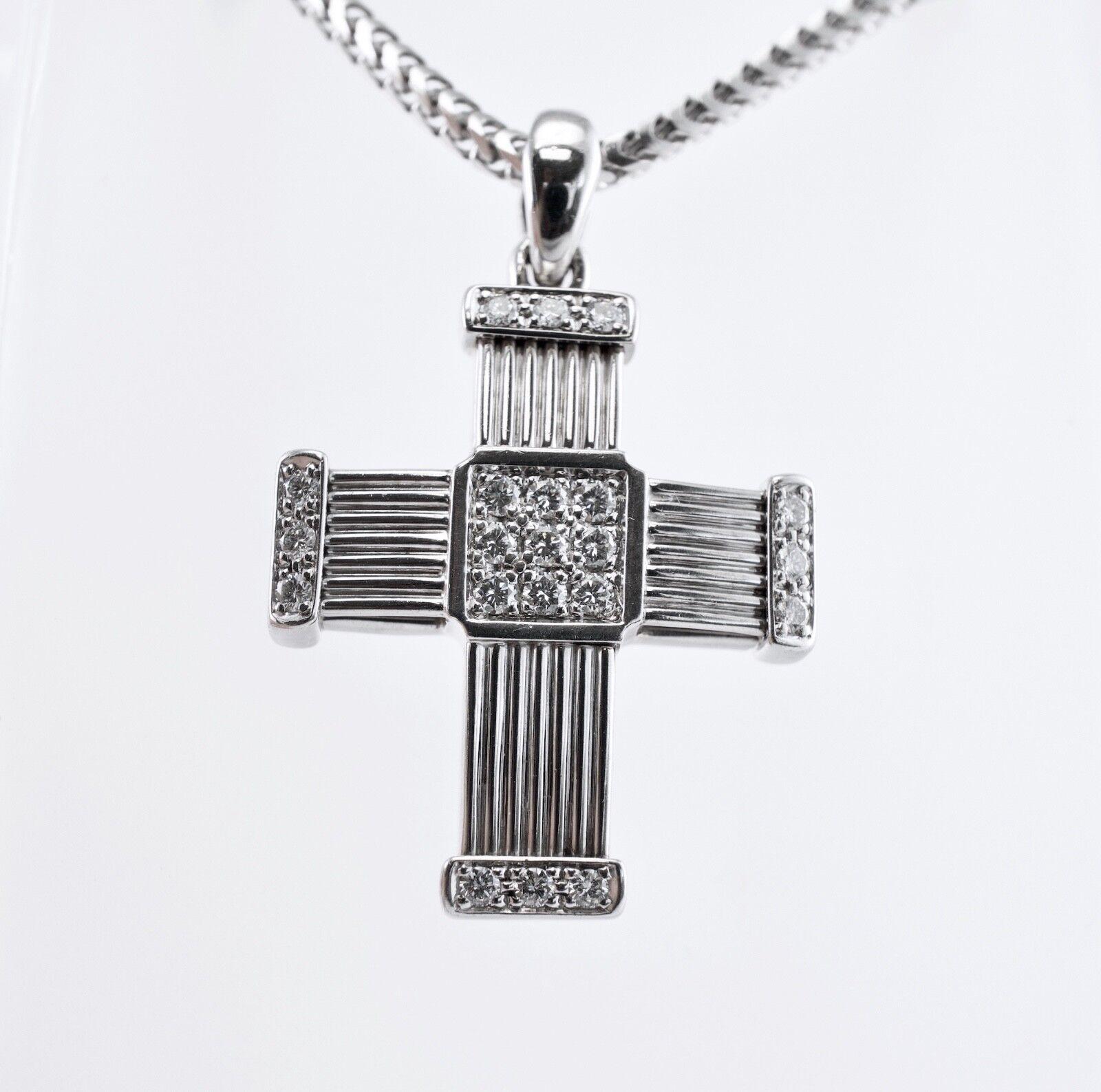 Diamond Cross Necklace Cross Pendant 18K Gold  by Di Modolo

This rare authentic Di Modolo Cross necklace is crafted in solid 18K White gold and set with white and fiery diamonds. Twenty-one round brilliant cut diamonds of VS1 clarity and G color