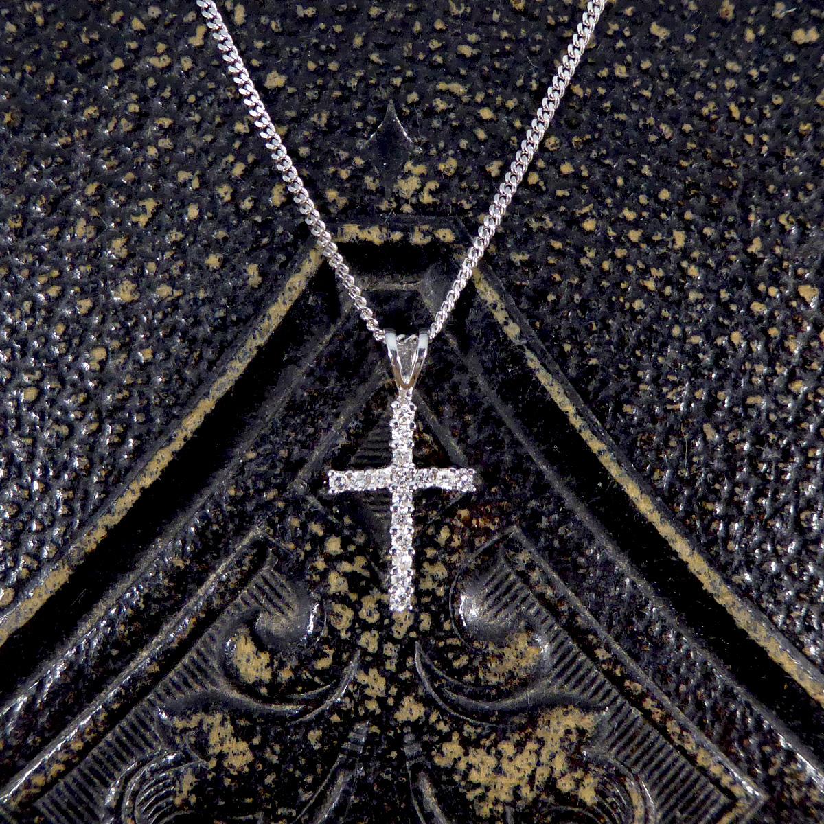 Discover the refined elegance of this Diamond necklace, featuring a delicate cross pendant adorned with 0.10ct of sparkling diamonds, set in 18ct White Gold. Suspended on a 18-inch 18ct White Gold chain, this necklace is a symbol of grace and faith