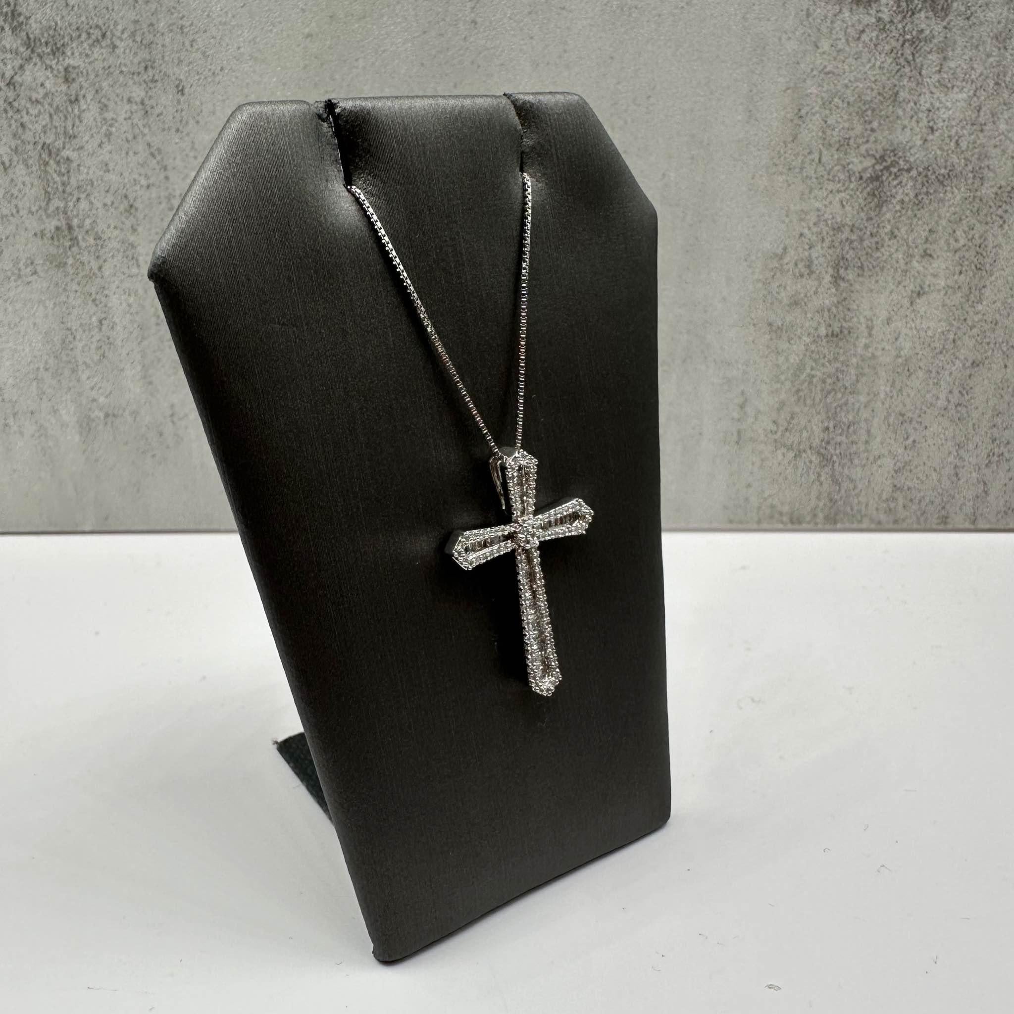 This elegant Diamond Cross Necklace in sterling silver features approximately 0.60ctw of natural HI SI baguette and round single-cut diamonds, adding brilliant sparkle to the beautiful cross design. The 18-inch length is ideal for layering or