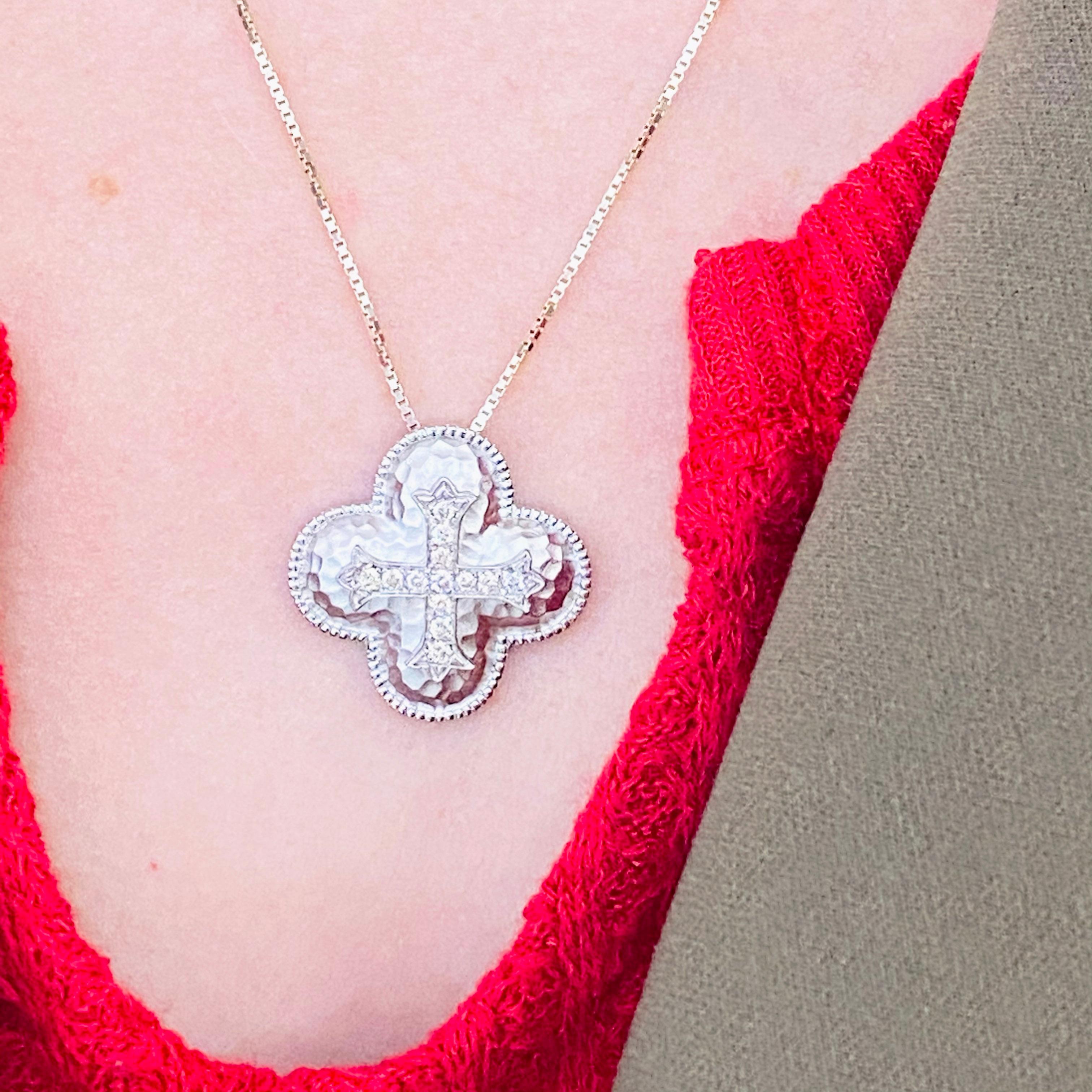 This gorgeous diamond cross pendant is a stunning and striking design. The cross pendant is made in 925 sterling silver with genuine, natural diamonds. The pendant was designed to be hammered with the diamond cross in the center.  The metal is a