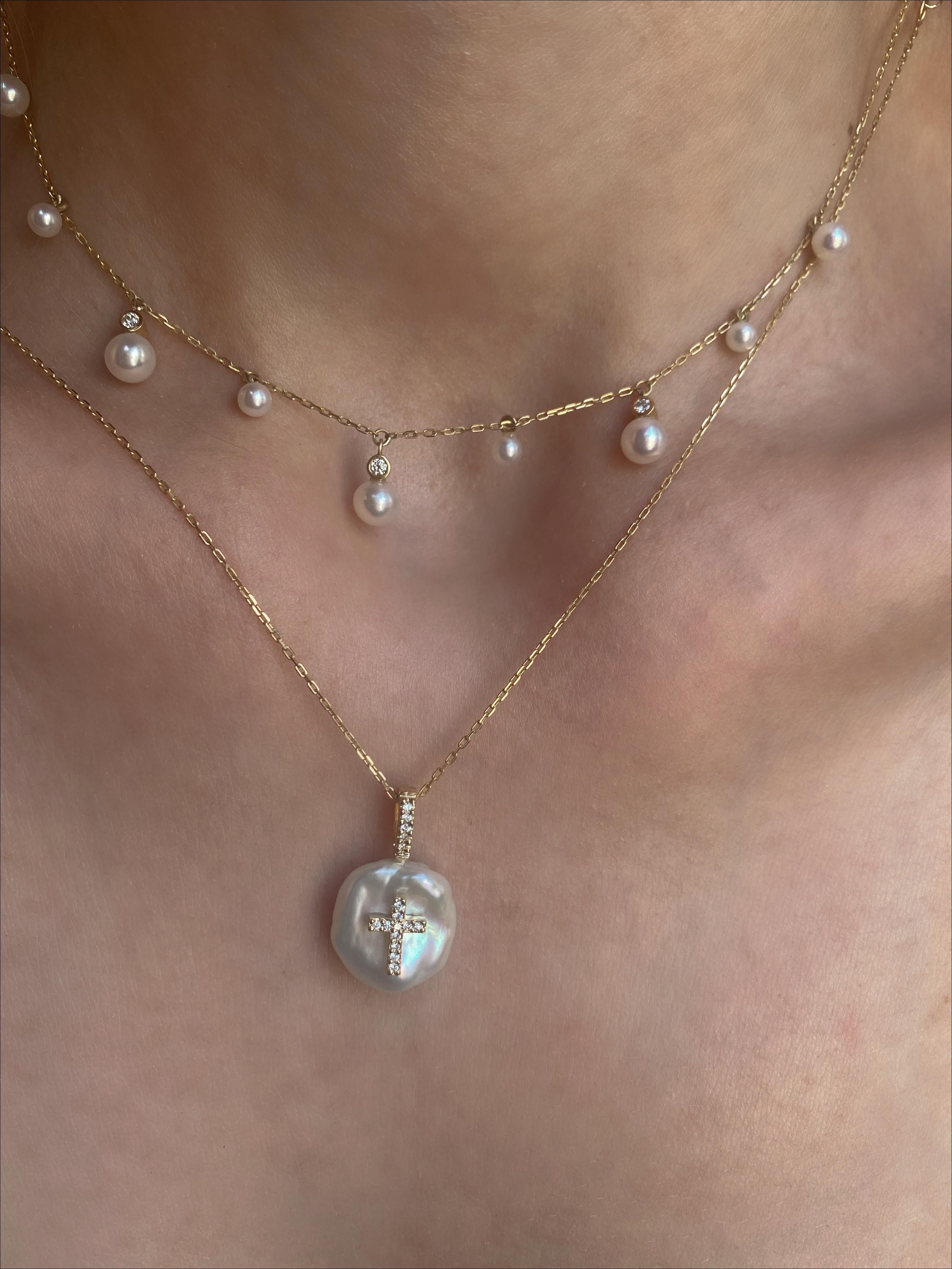 Our version of a classic diamond cross, is made with 18Karat Yellow Gold and set with natural glimmering diamonds on a freshwater petal shaped pearl.
Each petal pearl is handpicked for its luster and one-of-a-kind beautiful appearance and some