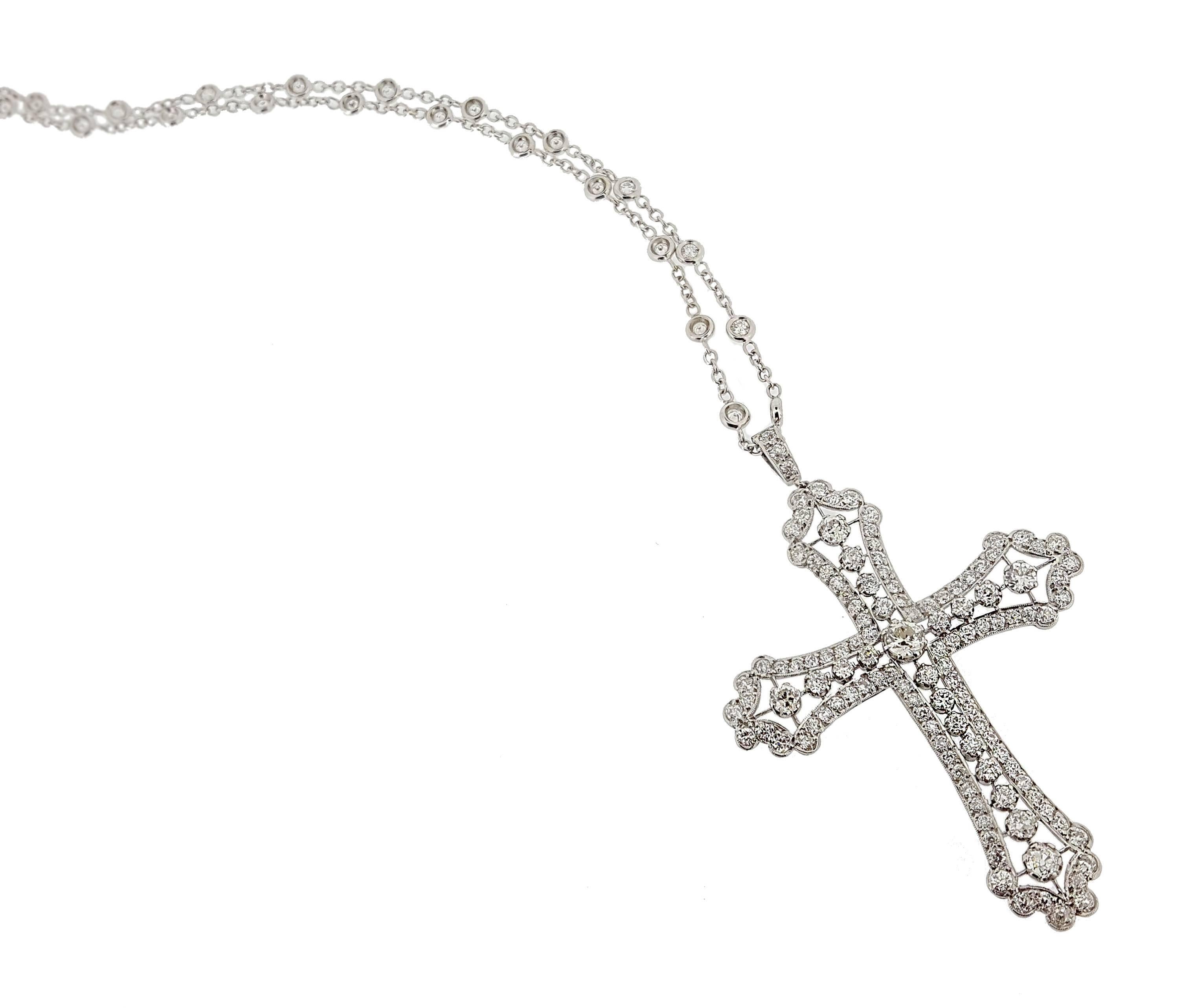 This beautiful, large, diamond cross pendant and diamond station chain boasts approximately 4.50ctw of sparkling diamonds. The pendant measures 2.5 inches long including bail, and 1.75 inches across. The chain itself, is 16 inches long and secured