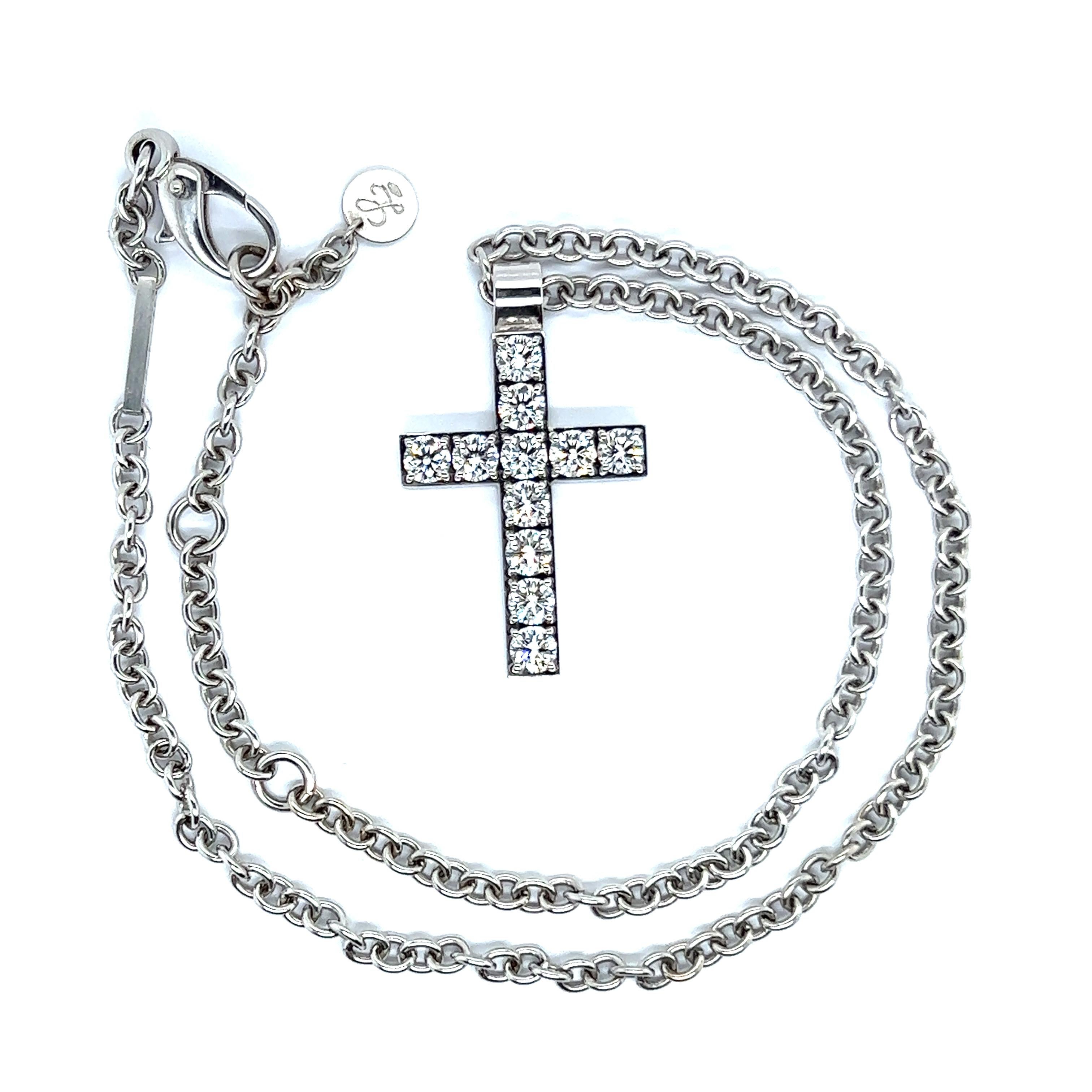 Crafted in 18k white gold, this impressive diamond cross is set with 11 brilliant-cut diamonds totaling 3.30 carats. Each diamond of fine D/if quality is accompanied by one GIA report and 10 IGI reports. 

Modern pendant is paired with a matching