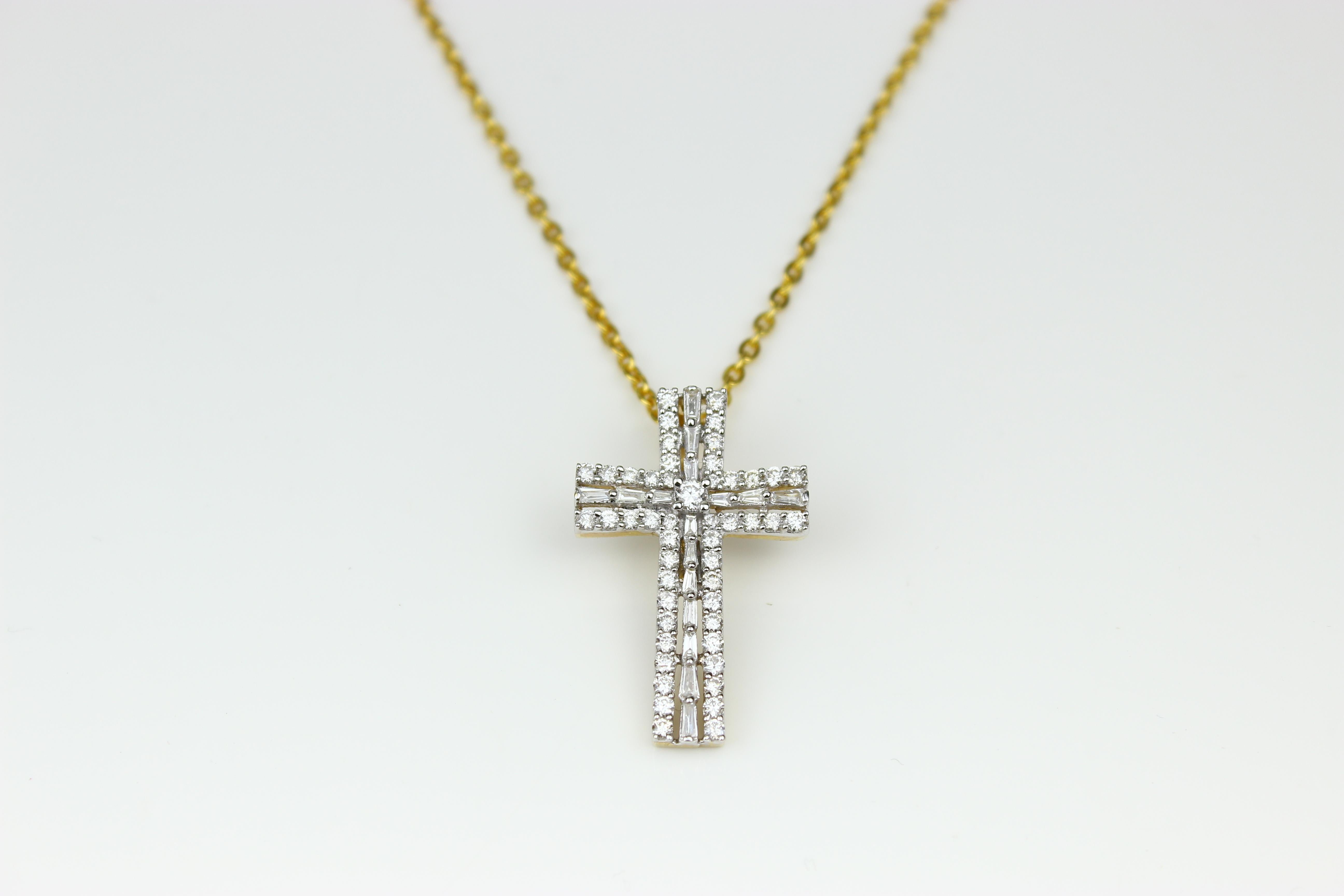 Symbol of FAITH...

Features baguette cut diamonds with dainty round diamonds around them. Made with the highest quality natural diamonds on a 100% guaranteed 18k solid gold. 

THE STONES-
This pendant consists of baguette natural diamonds weighing