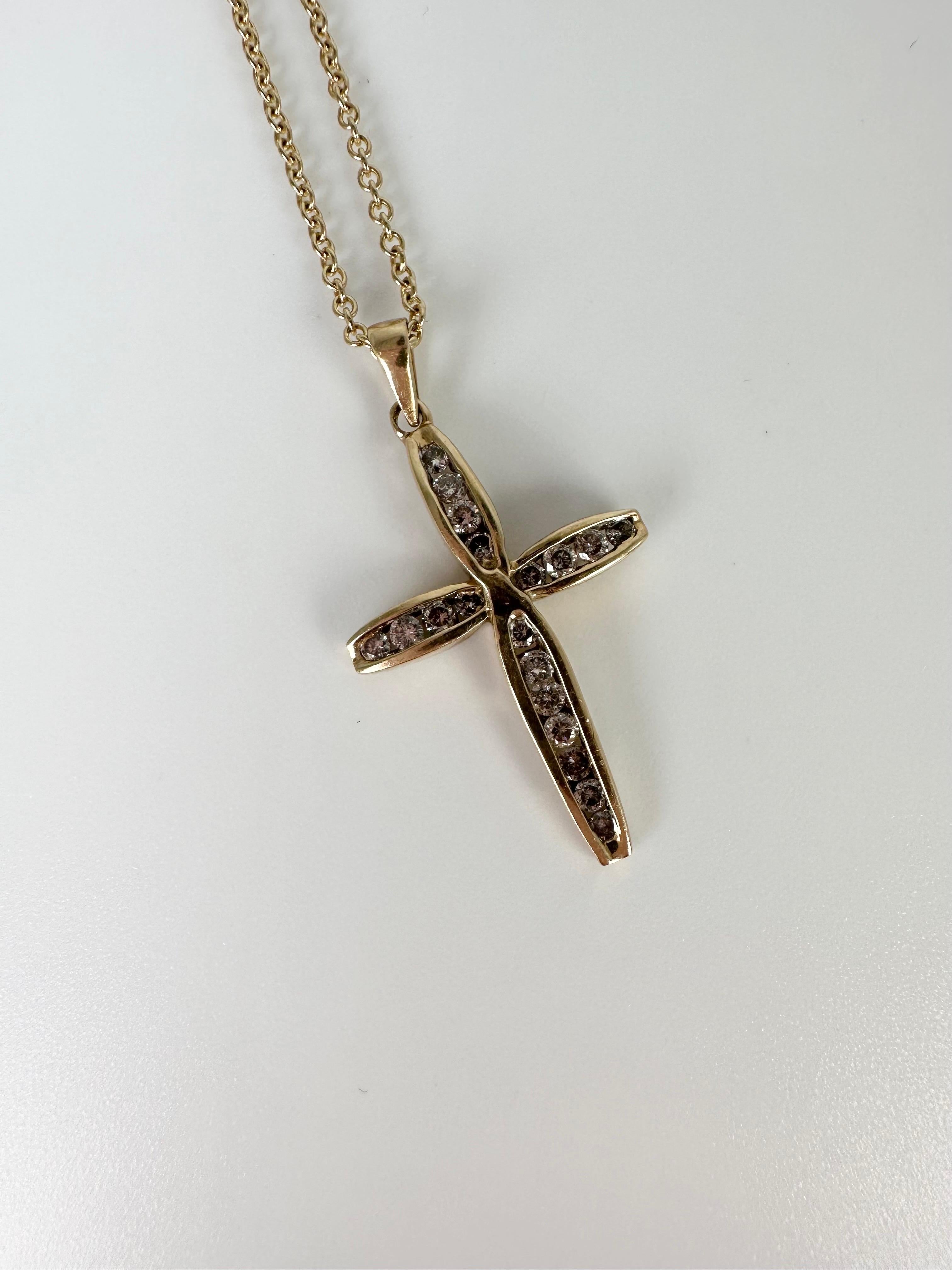 Simple channel set diamond cross in 10KT yellow gold, vry minimalistic with the right amount of sparkle. 
GOLD: 10KT gold
NATURAL DIAMOND(S)
Clarity/Color: SI/G
Carat:0.25ct
Grams:2.13
160-88PI
Chain: 18