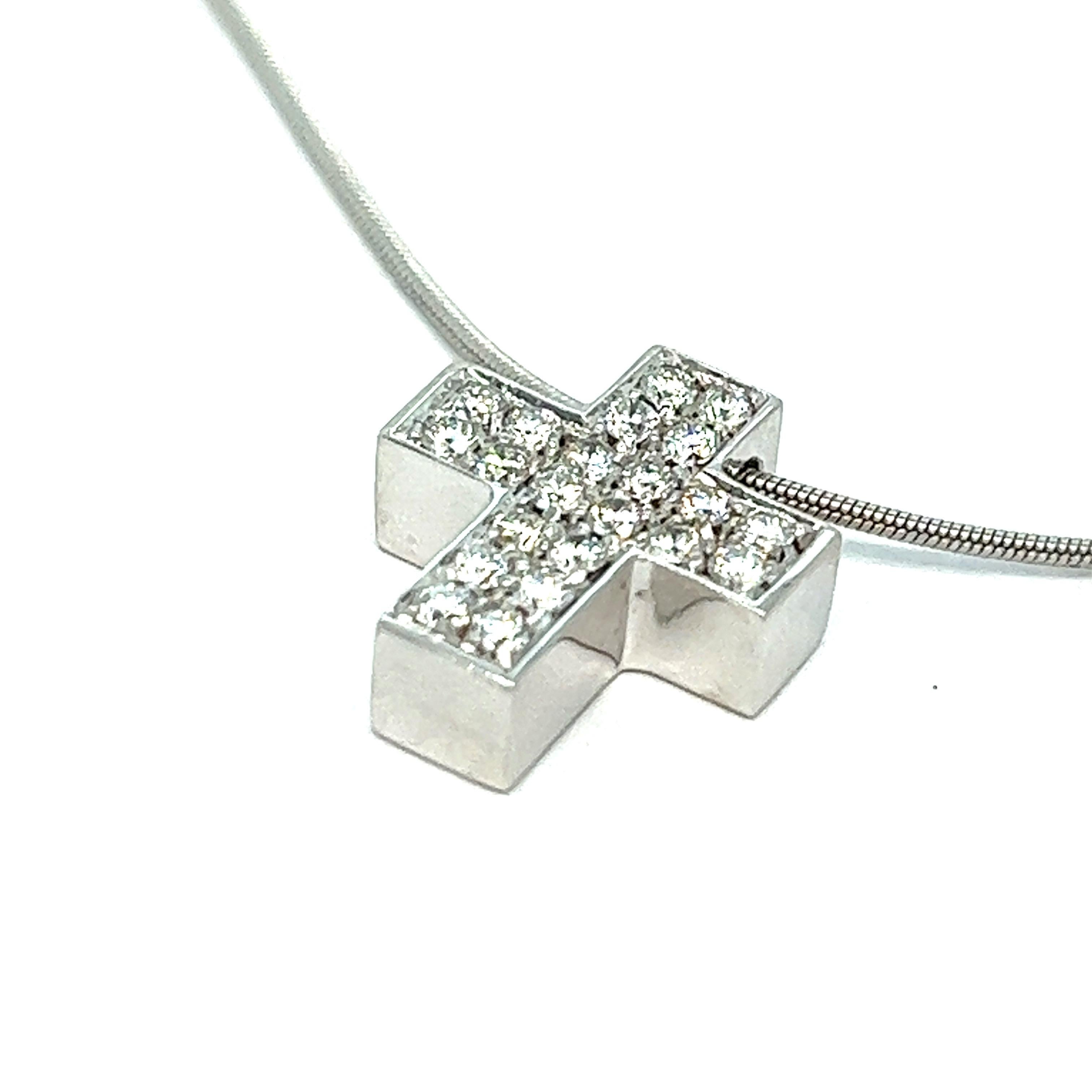 Diamond cross pendant necklace, made in Italy

Round-cut diamonds of 0.70 carat, 18 karat white gold; marked 750

Size: pendant width 1.2 cm, length 1.4 cm; chain length 15.75 inches
Total weight: 6.5 grams