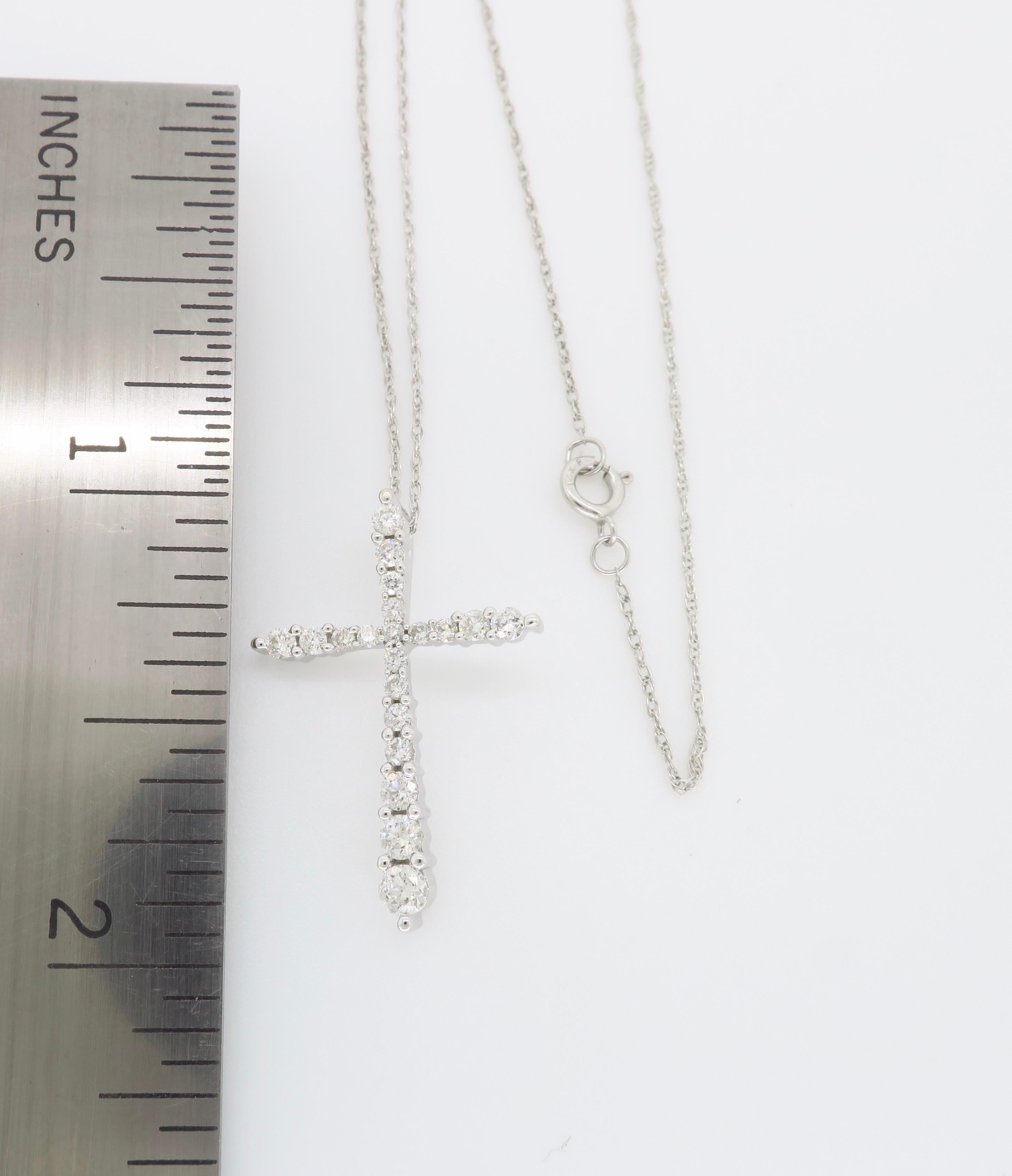 Graduated diamond cross pendant necklace crafted in 14k white gold.

Diamond Carat Weight: Approximately .40CTW
Diamond Cut: Round Brilliant Cut Diamonds
Color: Average G-I
Clarity: Average I
Metal: 14K White Gold
Marked/Tested: Stamped “14KT”