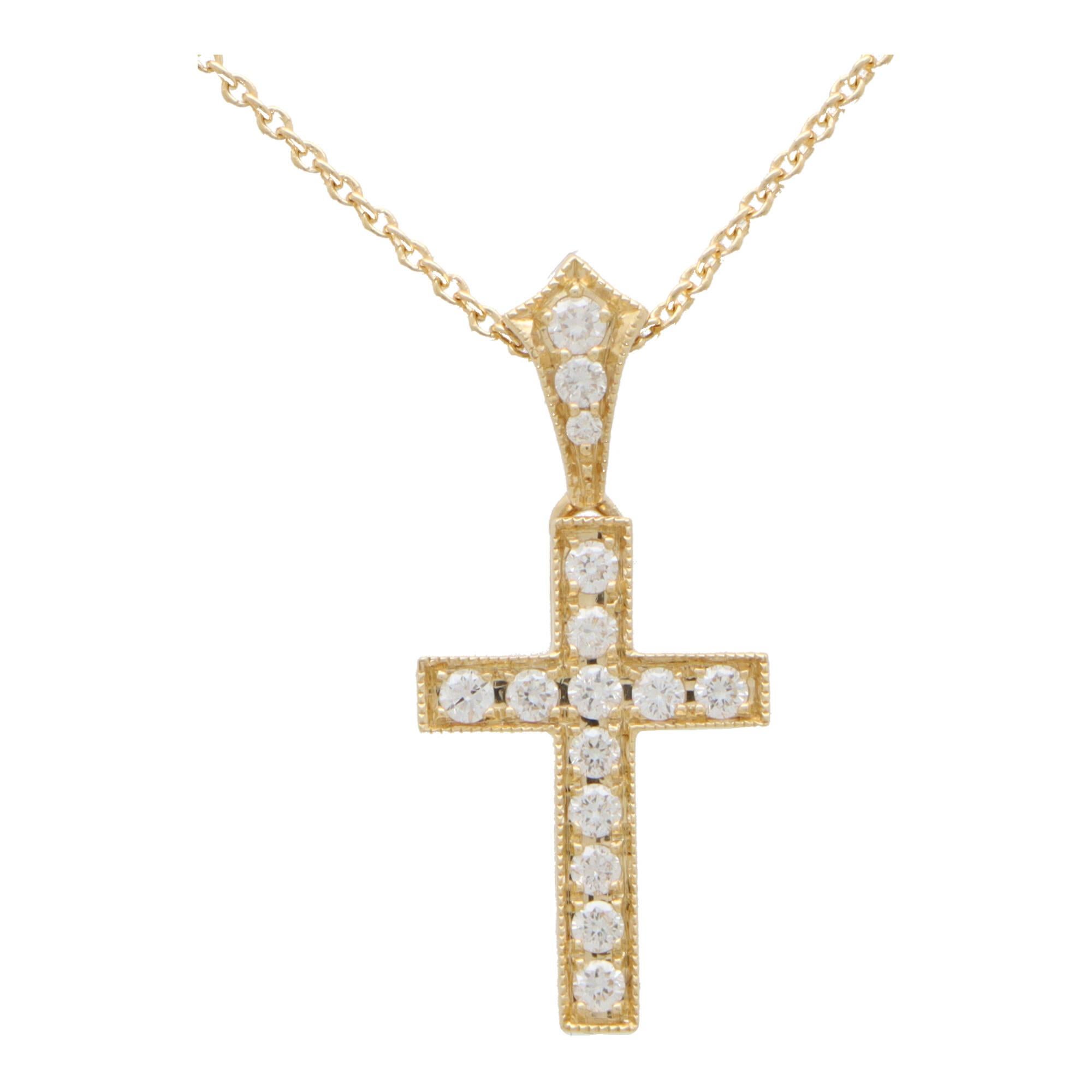  A beautiful diamond cross pendant necklace set in 18k yellow gold.

The pendant depicts a cross motif and is pave set with exactly 12 round brilliant cut diamonds. The cross hangs from a diamond set bail which is also set with graduating diamonds.