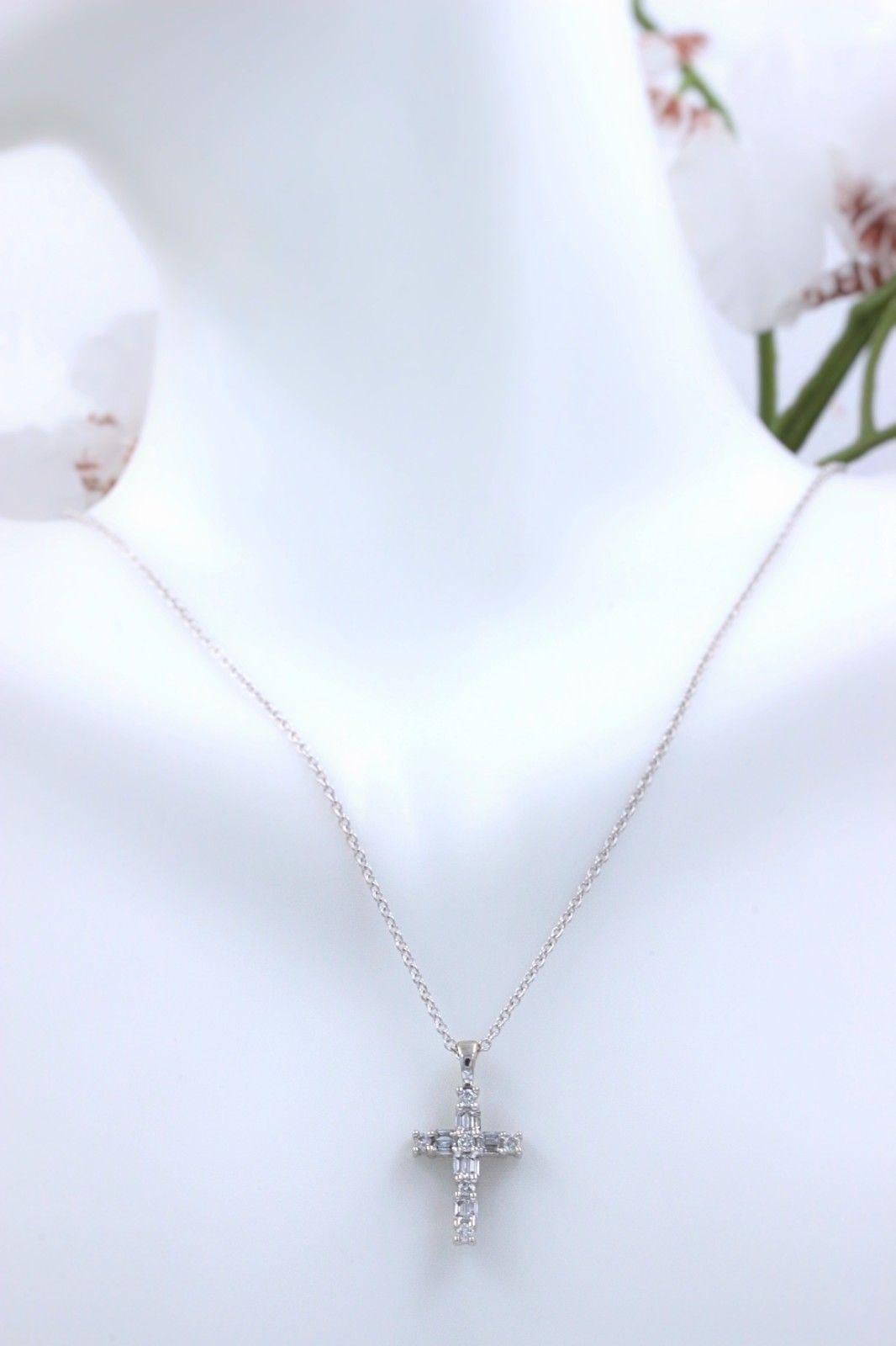 Style: Diamond Cross Pendant Necklace
Metal: 14k White Gold
Measurements:  0.75 inches length and 0.45 inches wide
Necklace Length:  18 inches
Total Carat Weight: 0.50 tcw
Diamond Shape: 6 Round Cut  0.20 tcw and 10 Baguettes 0.30 tcw
Diamond Color