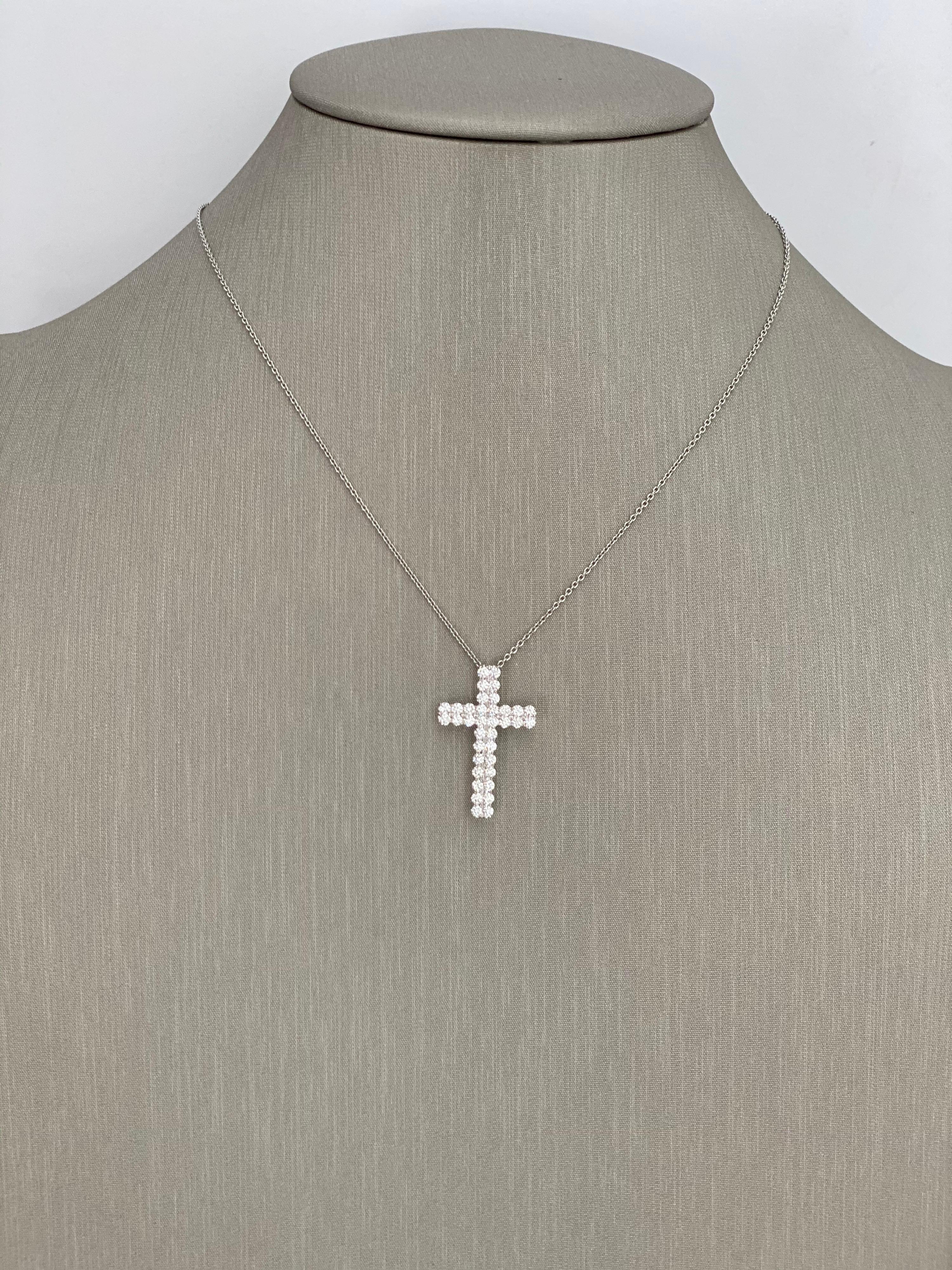Diamond Cross Pendant Necklace with 1.01 Carats of F-G colored brilliant round cut stones.  The diamonds are meticulously hand set in shared prongs to show more of the diamond,  We too had the back of the diamonds set  away from the gold all to