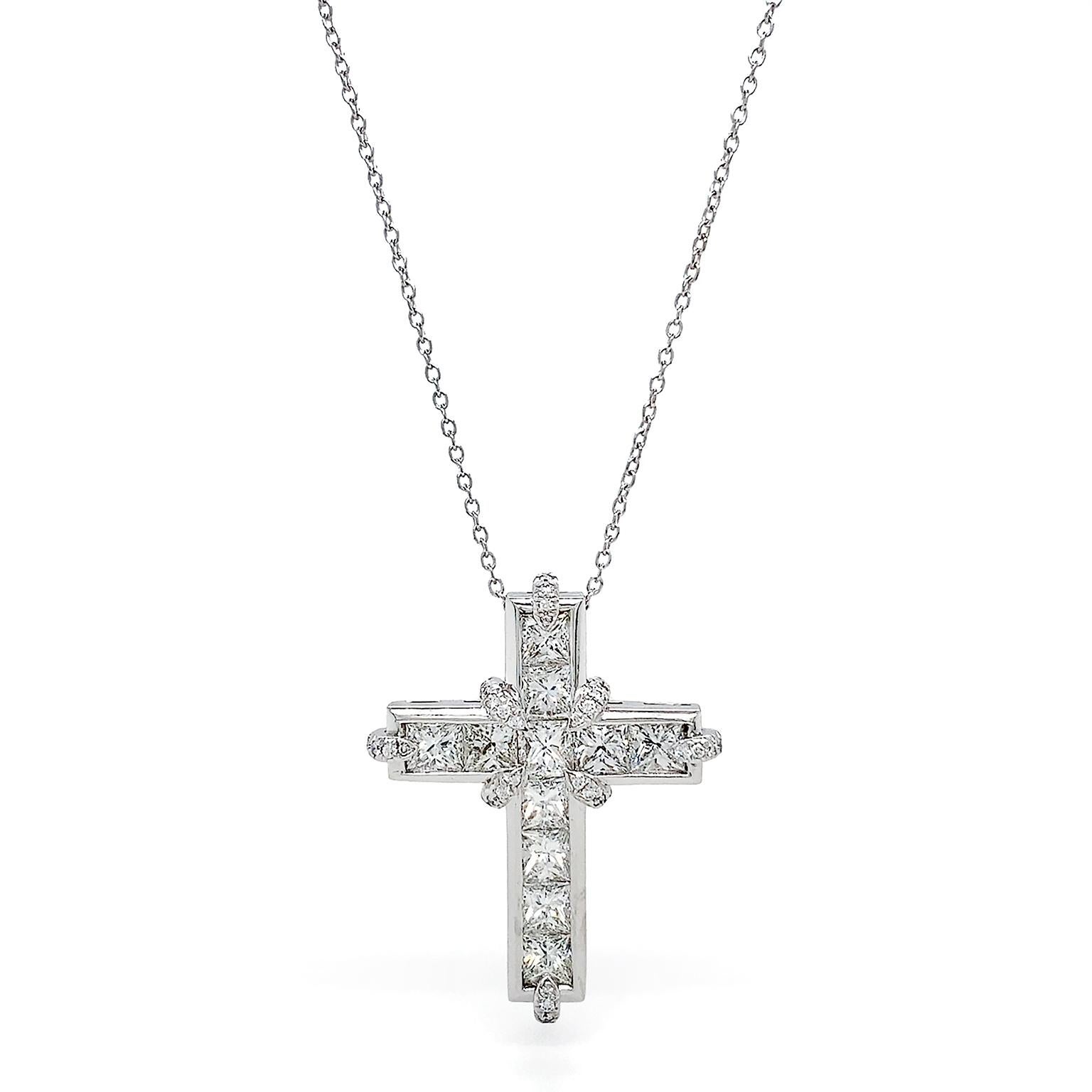 The radiant fire of princess cut diamonds create a cross for this pendant. The square shaped diamonds are channel set in platinum, while brilliant cut diamonds accent the inner corners and outer edges for additional sparkle. The collective weight is