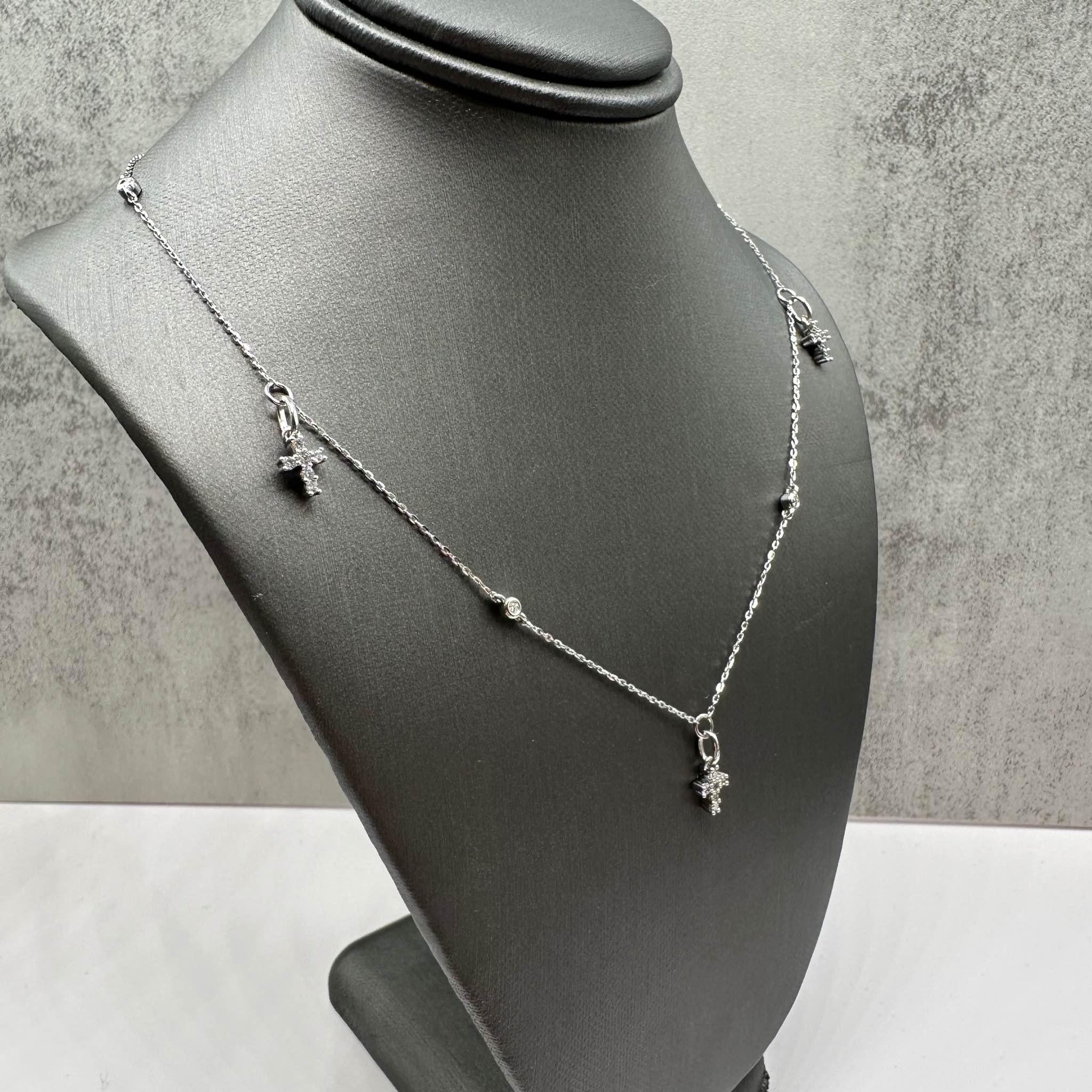 This elegant Diamond Cross Station Necklace in 10kt white gold features 0.34ctw of natural GH SI round diamonds, offering a brilliant sparkle with a modern cross design. The 18-inch length is perfect for layering or wearing alone, and the necklace