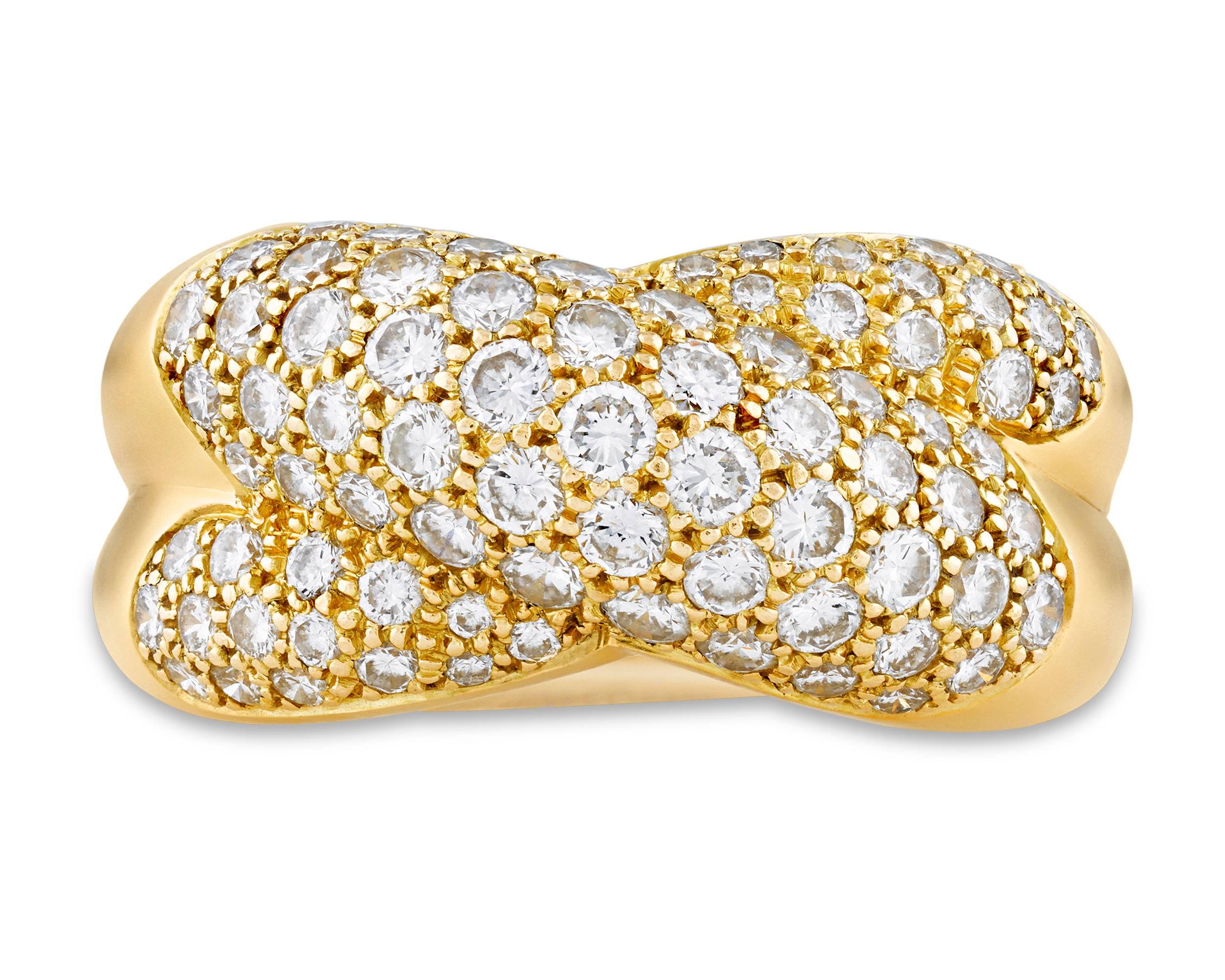 This classic crossover ring by the legendary Cartier is set with approximately 1.50 carats of white diamonds. The dynamic design is crafted of 18K yellow gold.

Marked 