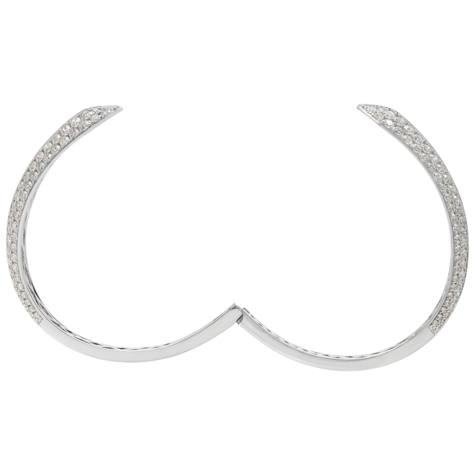 Diamond crossover semi eternity bangle with 7.04 carats in round brilliant cut diamonds (G-H Color, VS Clarity). Fits wrists up to 7 inches.
