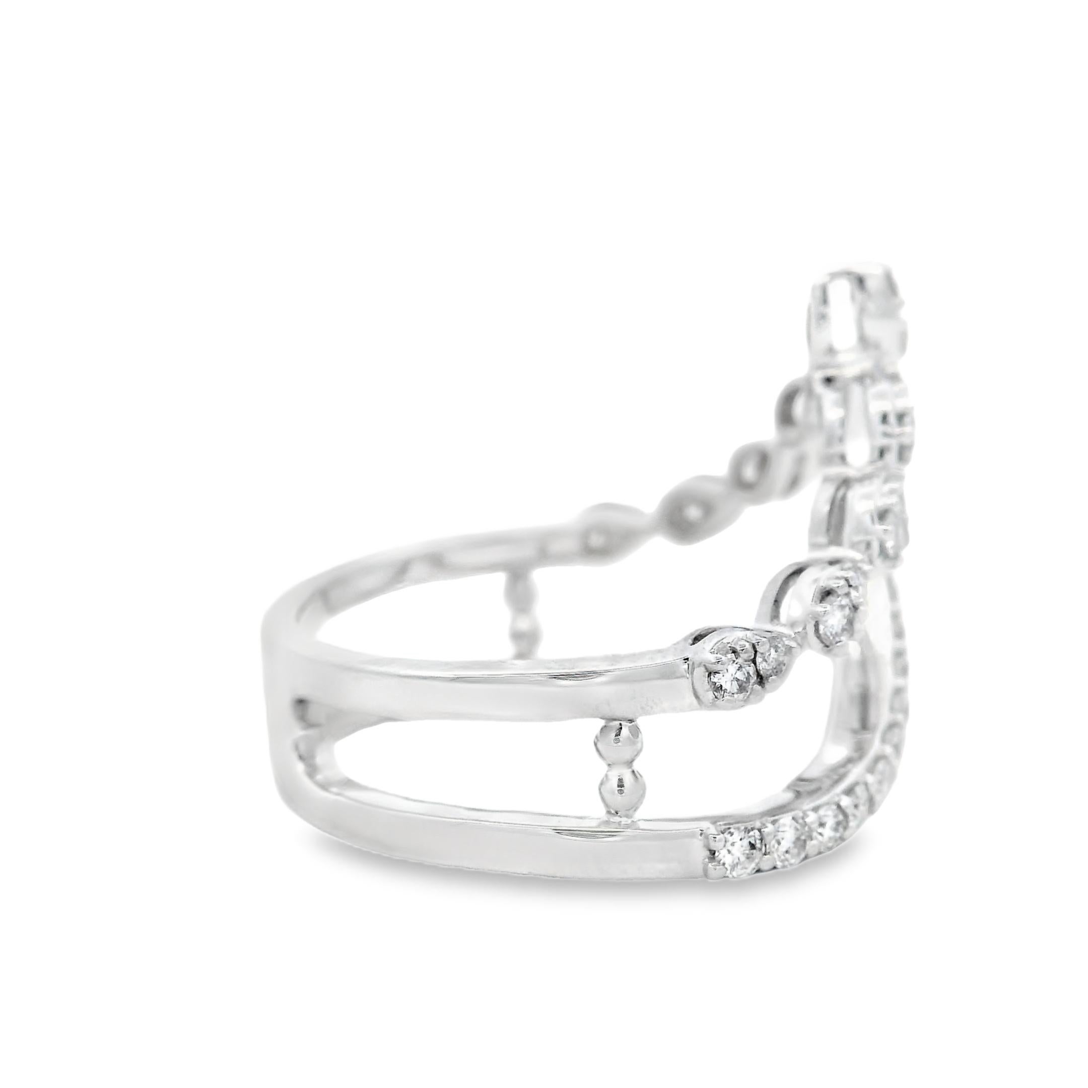 This crown-inspired diamond ring is crafted in rhodium-plated 14K white gold and features two sweeping rows of diamonds: one in a clean V-shaped curve, the other set in marquise-shaped pods for soft texture and lift. The pointed crown silhouette