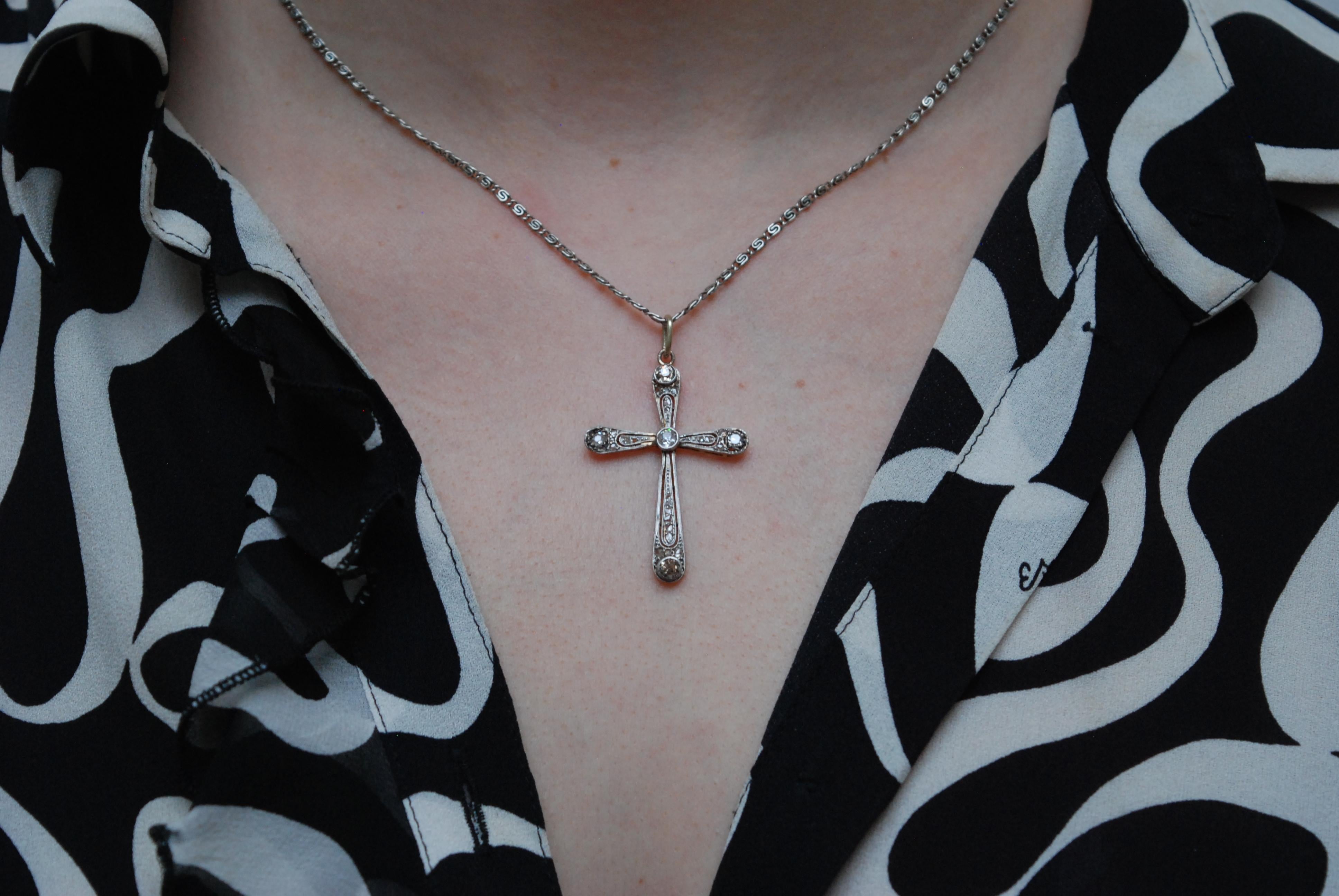 A Belle Époque diamond set cross with an old Europeancut diamond, rub set to the centre. Tapered cross bars with old eight cut and Swiss cut diamonds set at the ends, with rose cut diamonds milligrain set throughout. All set in white gold and backed