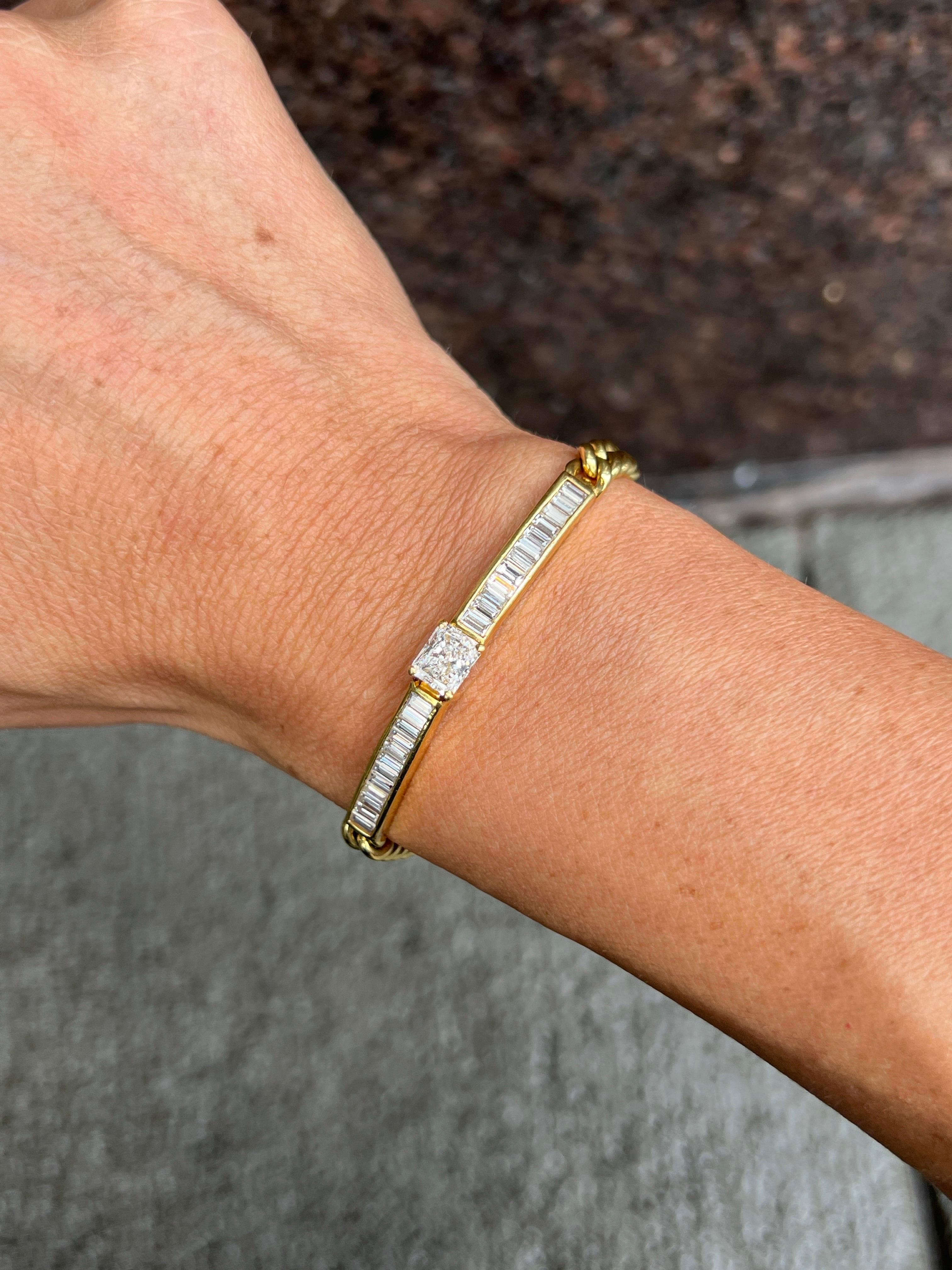 Diamond Cuban Link Bracelet

A Cuban link bracelet set with baguette cut diamonds and a larger princess cut diamond in the center.

Center Princess Cut Diamond Weight: approximately 1.00 carats

Measurements: 7