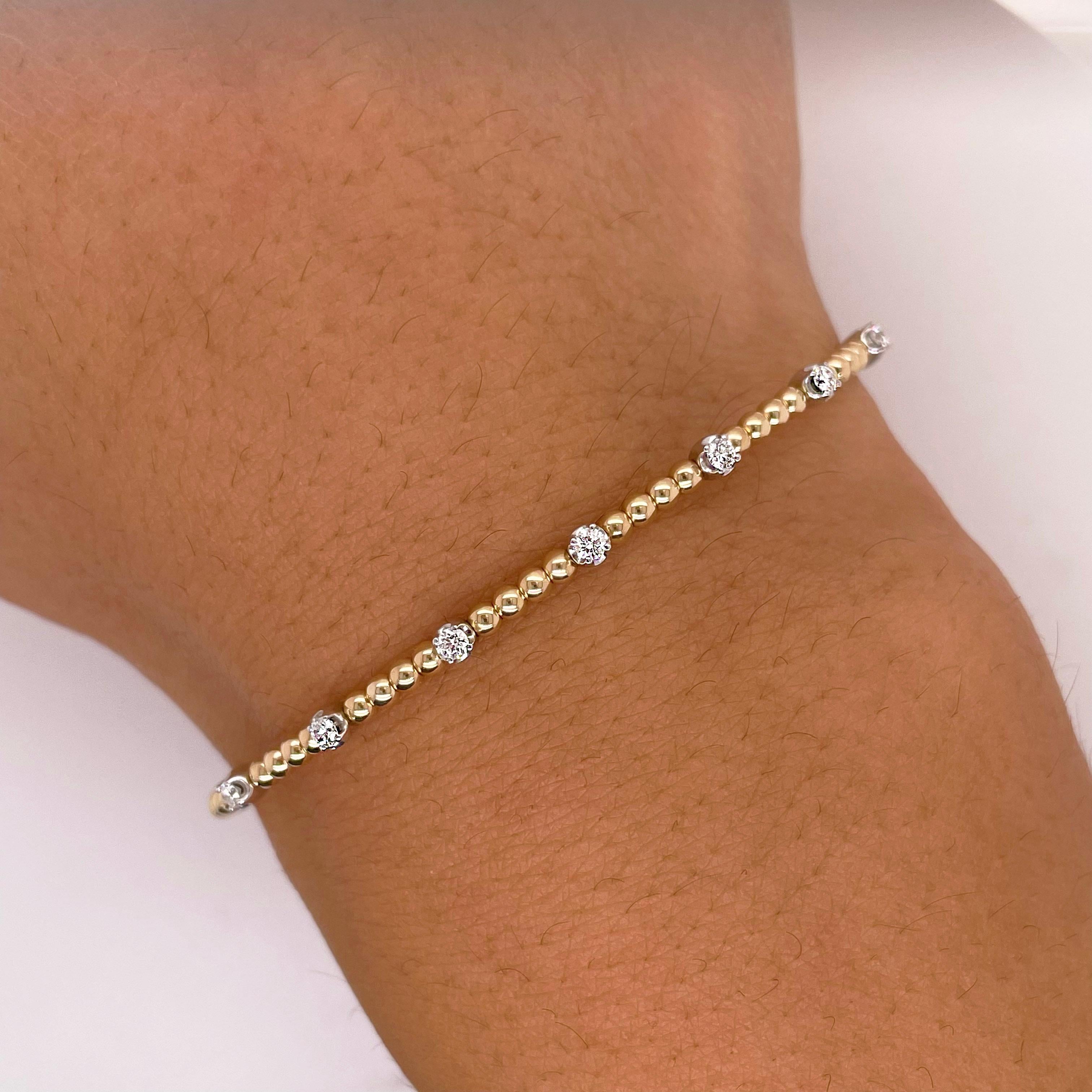 The details for this gorgeous bracelet are listed below:
Bracelet Type: Cuff, Bangle
Metal Quality: 14K White-Yellow Gold
Length: 6 cm (6.5 inches)
Width: 2.25 mm
Clasp: Flexible Bangle
Diamond Shape: Round Brilliant
Diamond Weight: .20