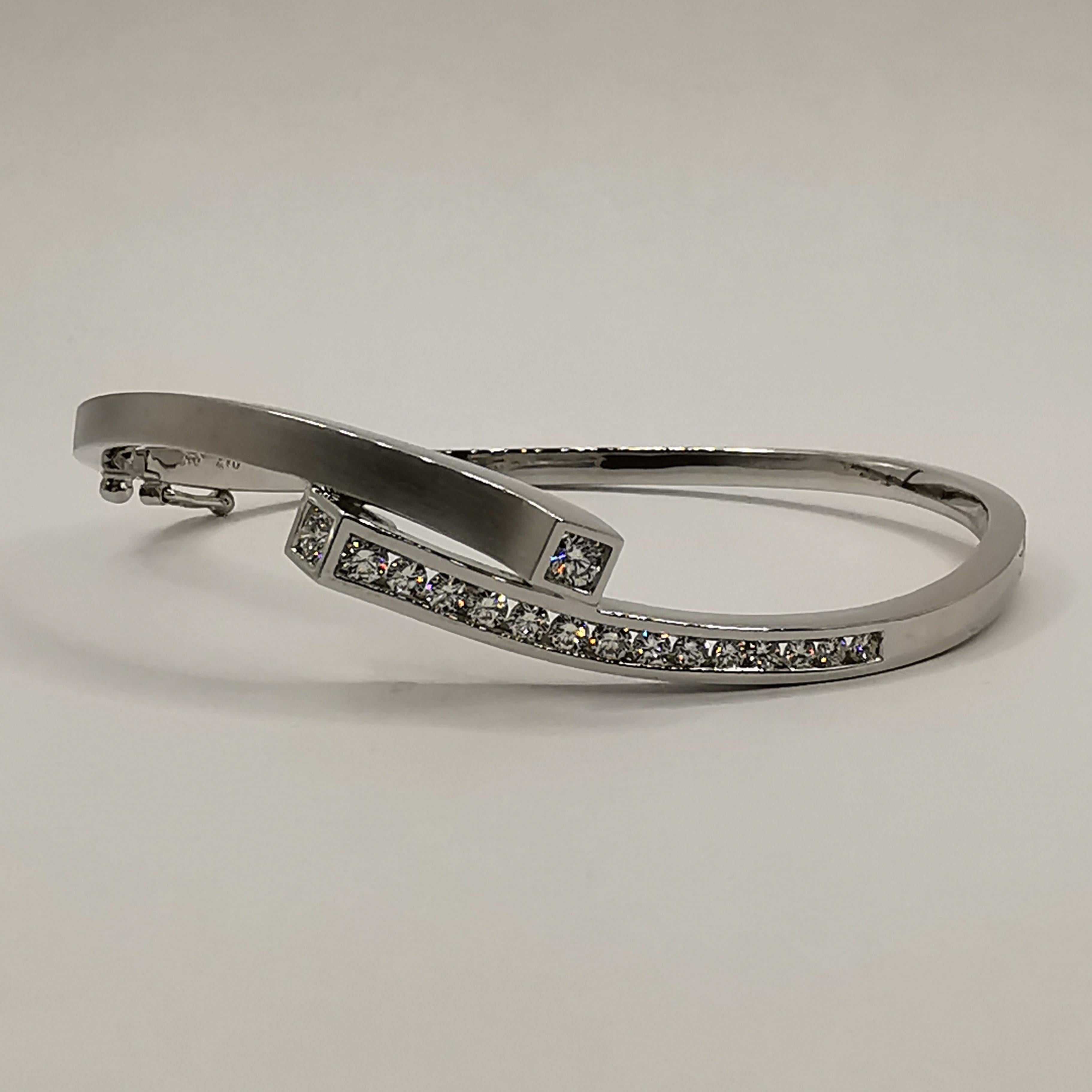 This luxurious diamond cuff bracelet is a true statement piece that will add a touch of glamour and sophistication to any outfit. Crafted from 18k white gold, the bracelet features a sleek and elegant design that is sure to turn heads. The bracelet