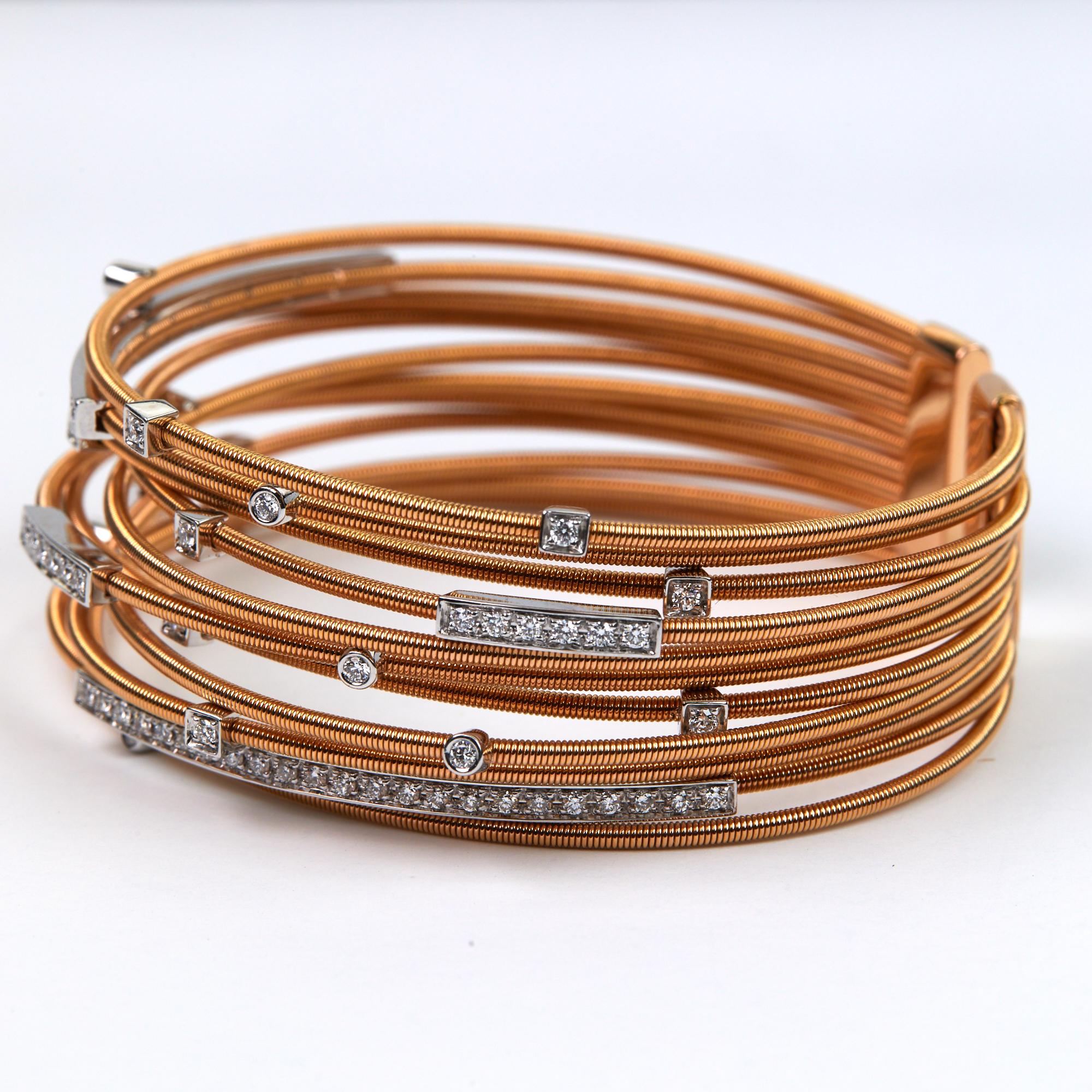 Diamond Gold Cuff Bracelet hand made in Italy.  This beautiful modern bracelet has 1.21 carats of brilliant round cut diamonds, all F-G color and VS clarity, set in 18 karat rose gold.  The rose gold coiled wire cords have white gold bars set onto