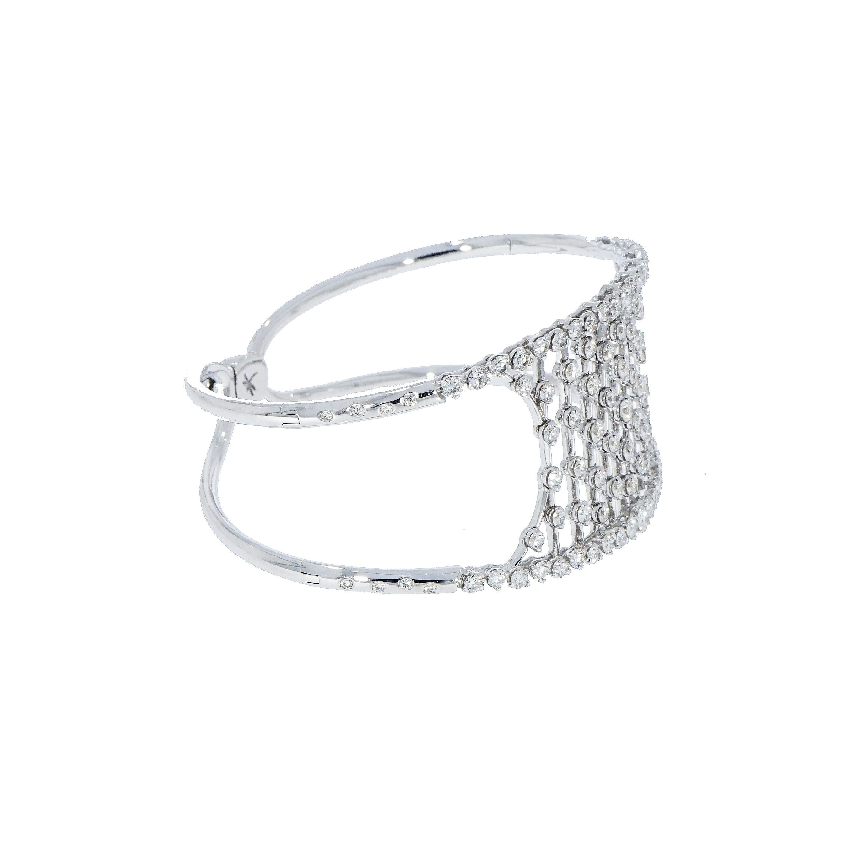 Born from the harmony of a unique design and the search for a seductive grace, this precious cuff bracelet is handcrafted in Italy by a master jeweler in 18k white gold.
Created with 111 Round Diamonds totaling 4.50 carats to radiate an