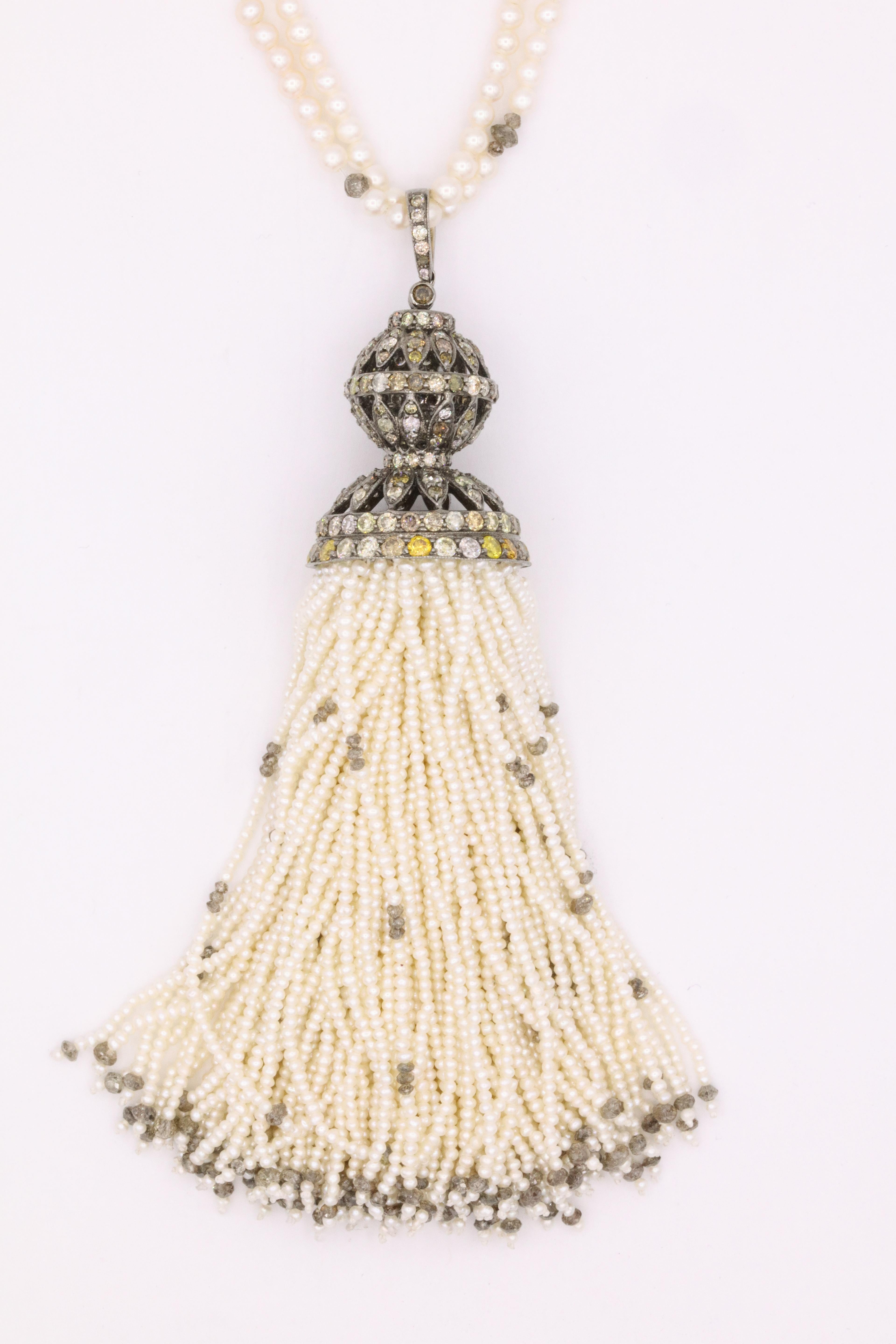 Gorgeous 51 inch tassel necklace featuring 124 tassel strands, measuring 4 1/2 inches, with touches of diamond beads throughout weighing approximately 7 carats and a pave diamond cap of cognac diamonds weighing approximately 5.50 carats. 
Can be