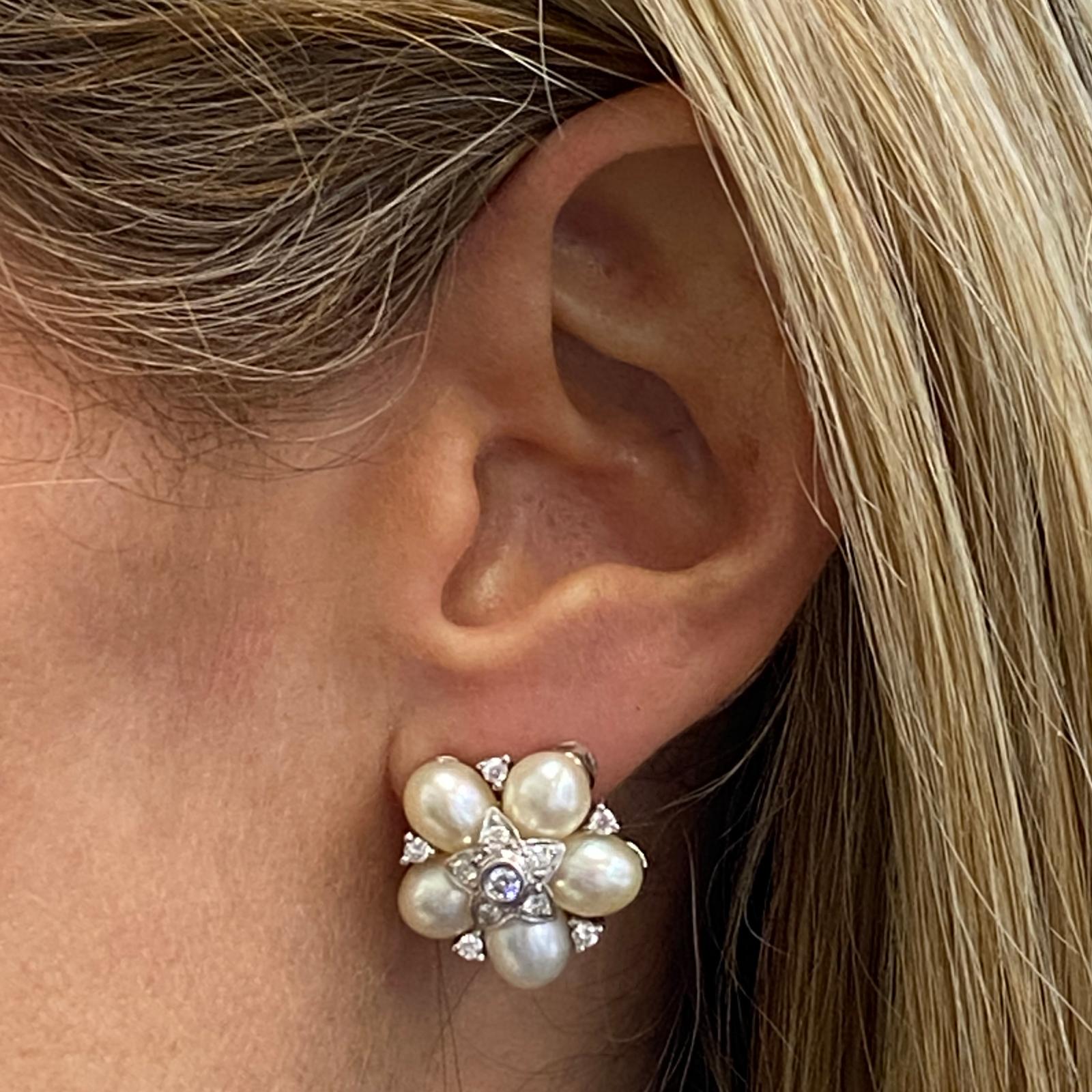 Diamond pearl estate earrings fashioned in 18 karat white gold. The earrings feature round brilliant cut diamonds weighing .50 carat total weight and graded G-H color and VS clarity. The earrings also are set with 10 white cultured pearls and