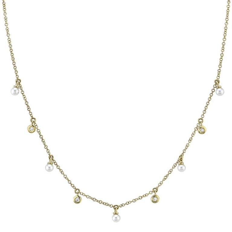 This beautiful 14 karat yellow gold diamond & cultured pearl necklace is a perfect everyday necklace. It has alternating diamonds and pearls that hang ever so gracefully. 
 
