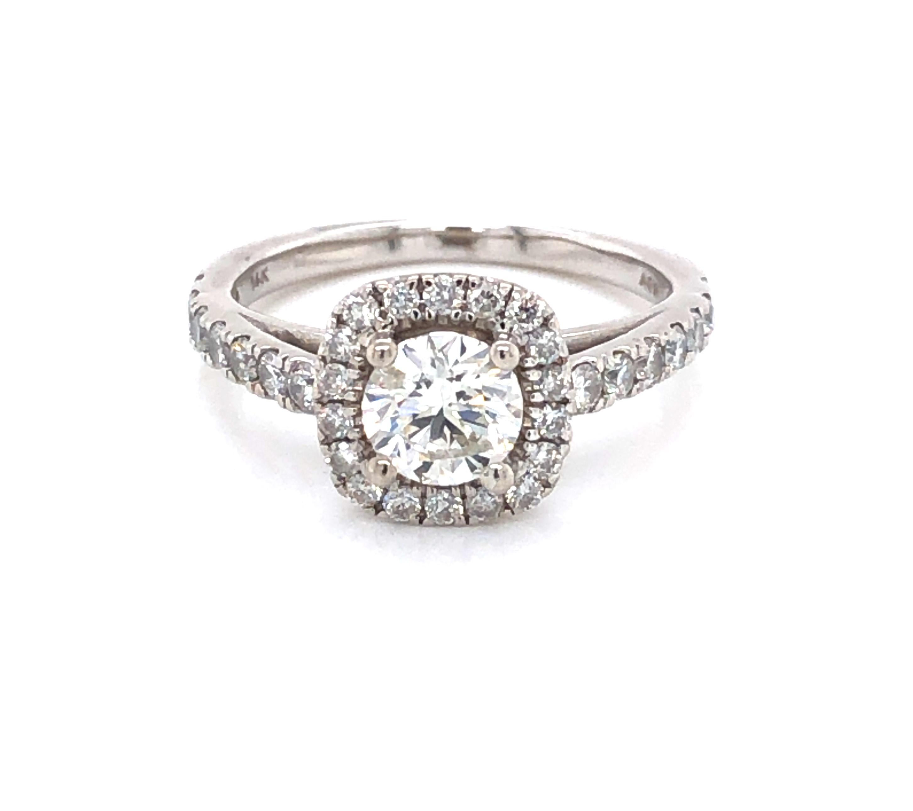 A beautiful and classic style that has plenty of sparkle and fire. The variety of shapes creates visual interest and adds flash to the center stone. In fourteen karat 14k white gold, the round .55 carat center H/SI1 diamond is complemented by a