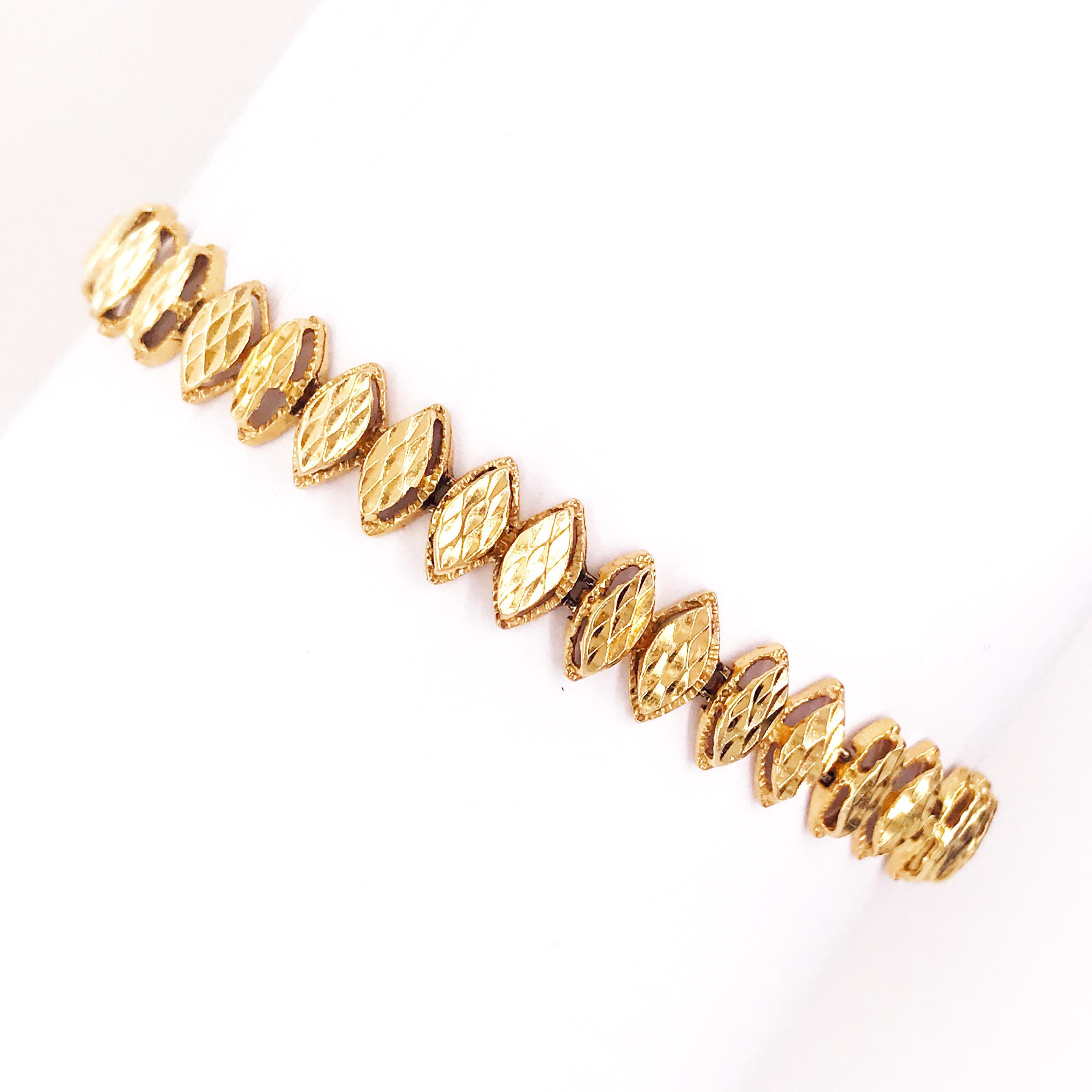 This is a fancy additional to any chain or charm bracelet collection. Each link is a marquise shaped gold piece that has been hand made and hand crafted together into an elegant, unique bracelet. The links have a diamond cut texture and high polish