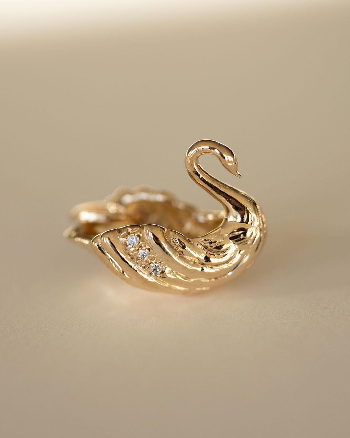 An ode to the northern constellation on the plane of the milky way. Swan pendant is adorned with diamonds and beautifully hand detailed.

A symbol of love, elegance and beauty. 

✧ 14K Solid Yellow Gold
✧ 1mm Brilliant Cut Diamonds
✧ Swan Measures