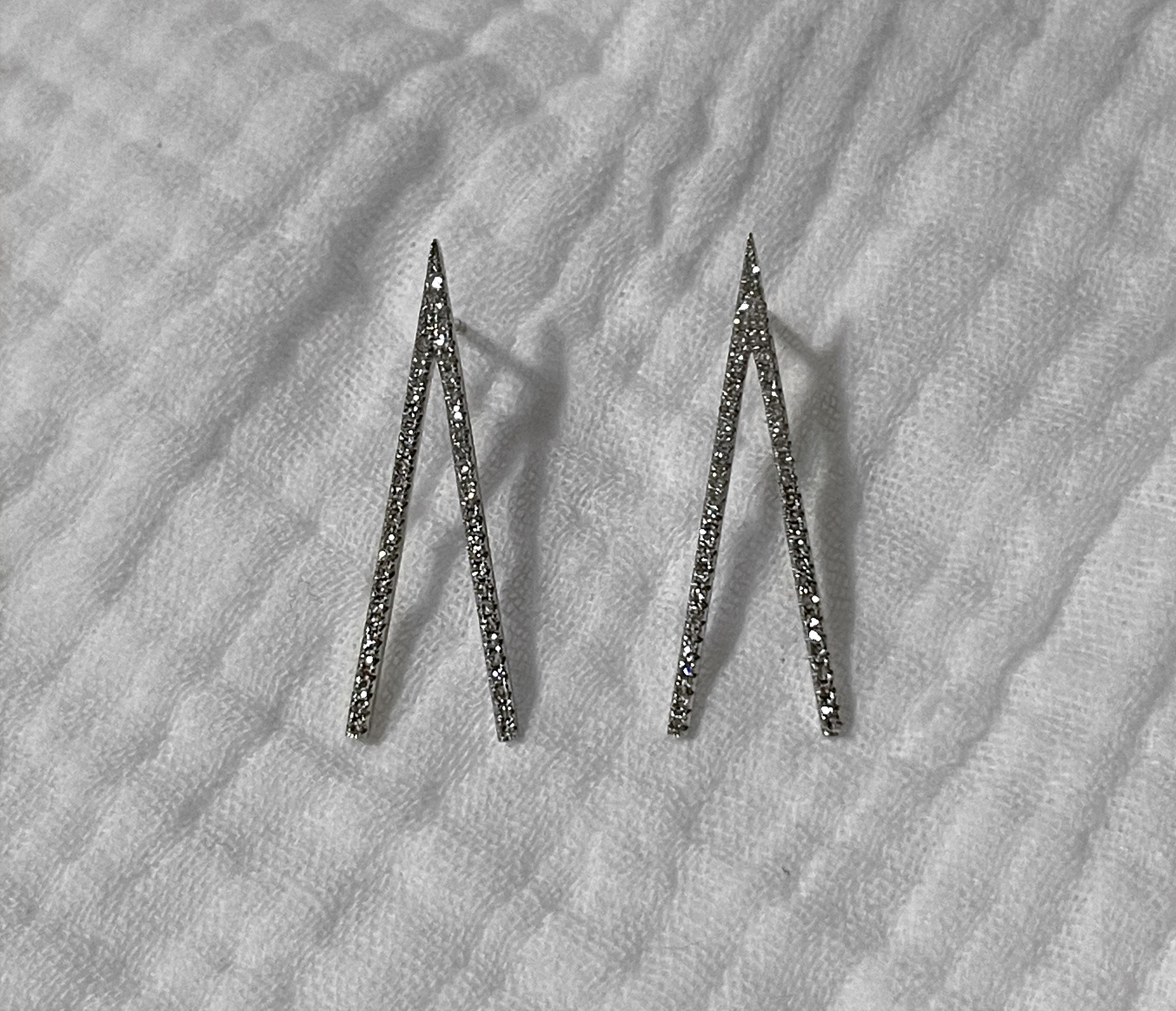 Indulge in the sheer elegance of our Diamond Dagger Earrings in 14k White Gold. Crafted with love and precision, these solid gold beauties are adorned with ethically sourced, natural diamonds that sparkle with every move. With a total diamond weight