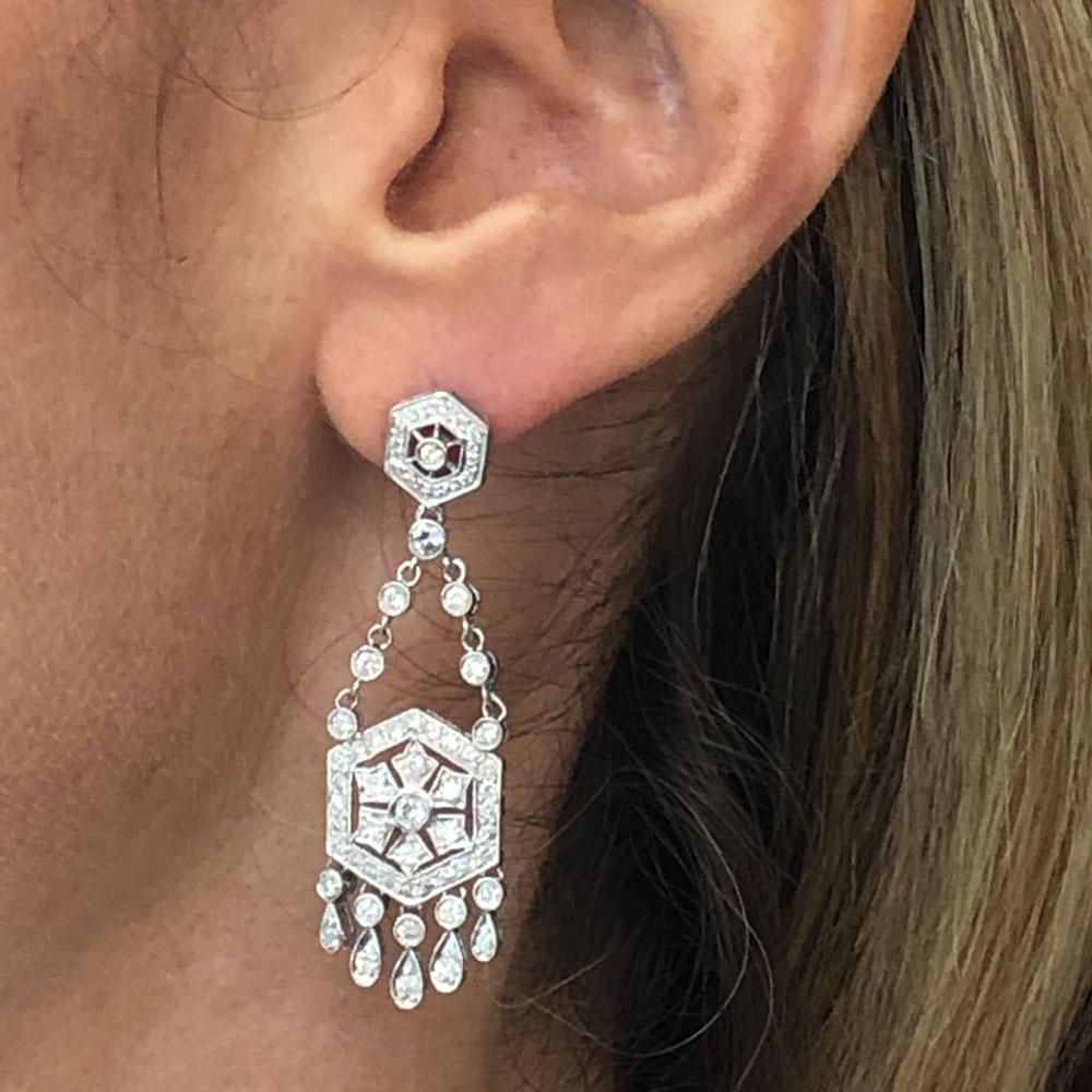 These fabulous diamond dangle chandelier earrings are crafted in 18 karat white gold. The 2.0 inch drops feature 1.72 carat total weight of round brilliant cut white diamonds graded H-I/SI. The earrings are just the right length and comfortable to