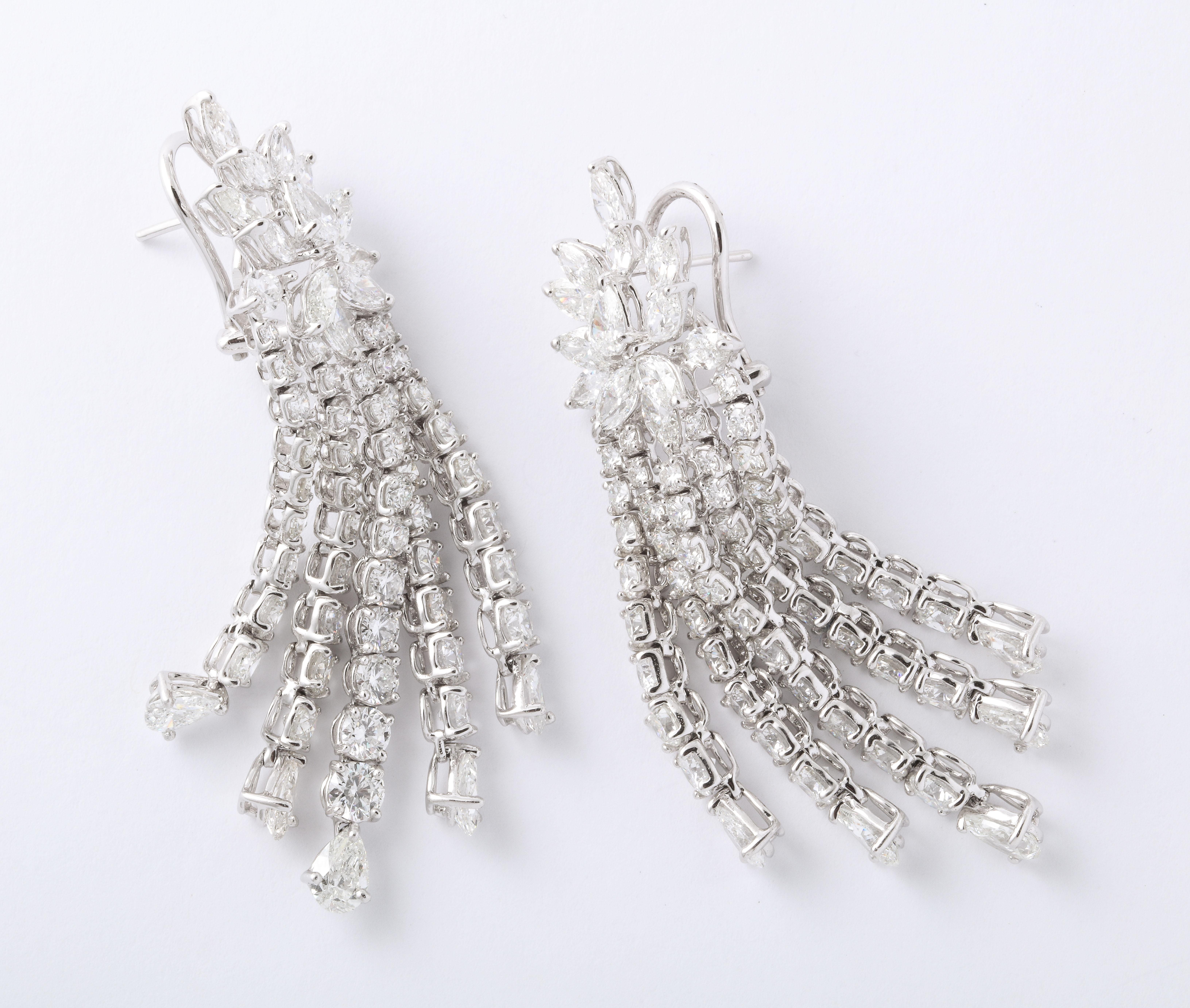 
A fabulous pair of timeless diamond earrings.

5 rows of round brilliant cut and pear shape strands dangle from pear shape and marquise clusters.

22.06 carats of white diamonds set in 18k white gold.

approximately 2.5 inches long, .60 inches at