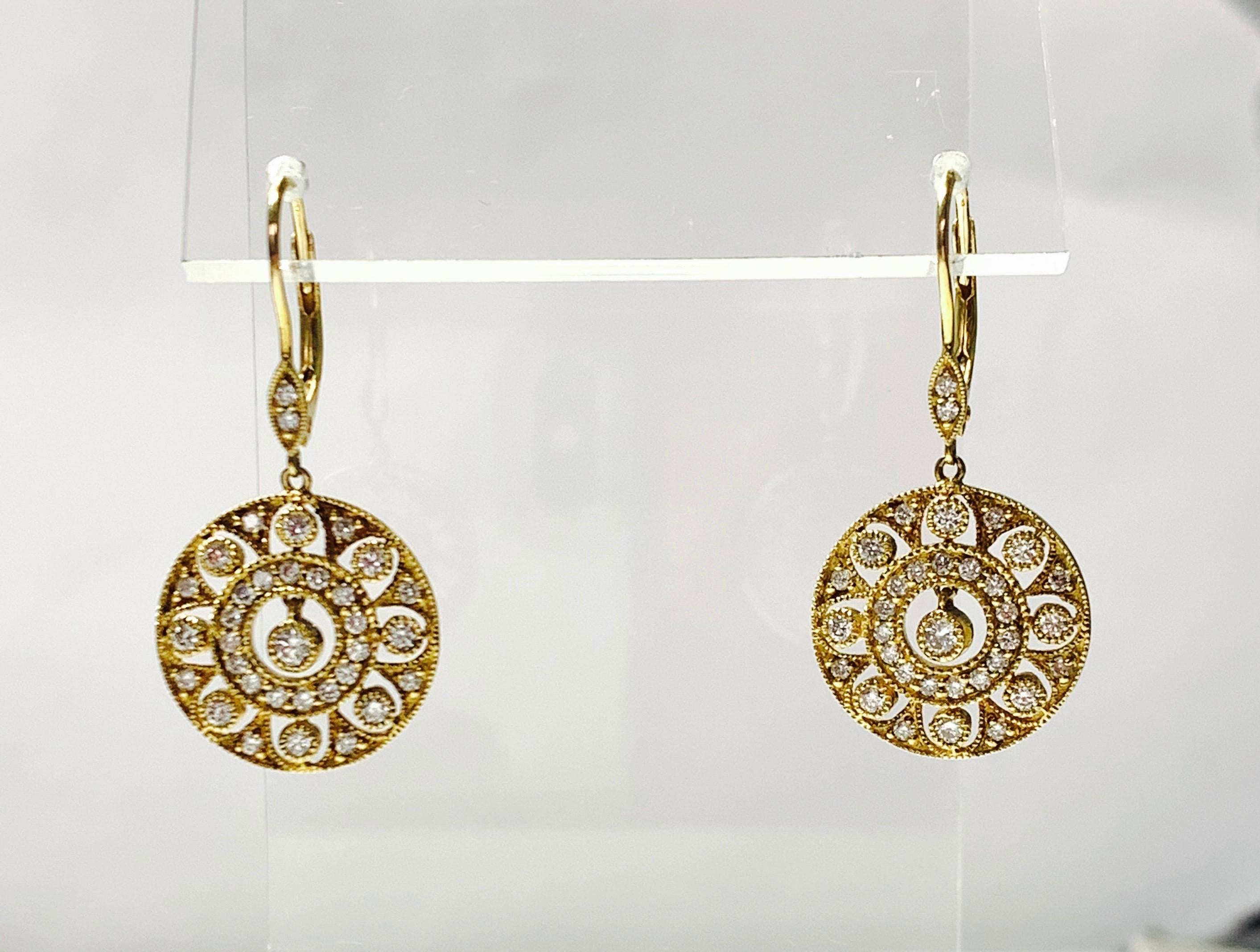 Diamond dangle earrings in 14k yellow gold. 
The details are as follows : 
Diamod weight : 1.20 carat ( GH color and VS clarity ) 
Measurements : length : 1.40 inch 
Metal : 14 K yellow gold 
