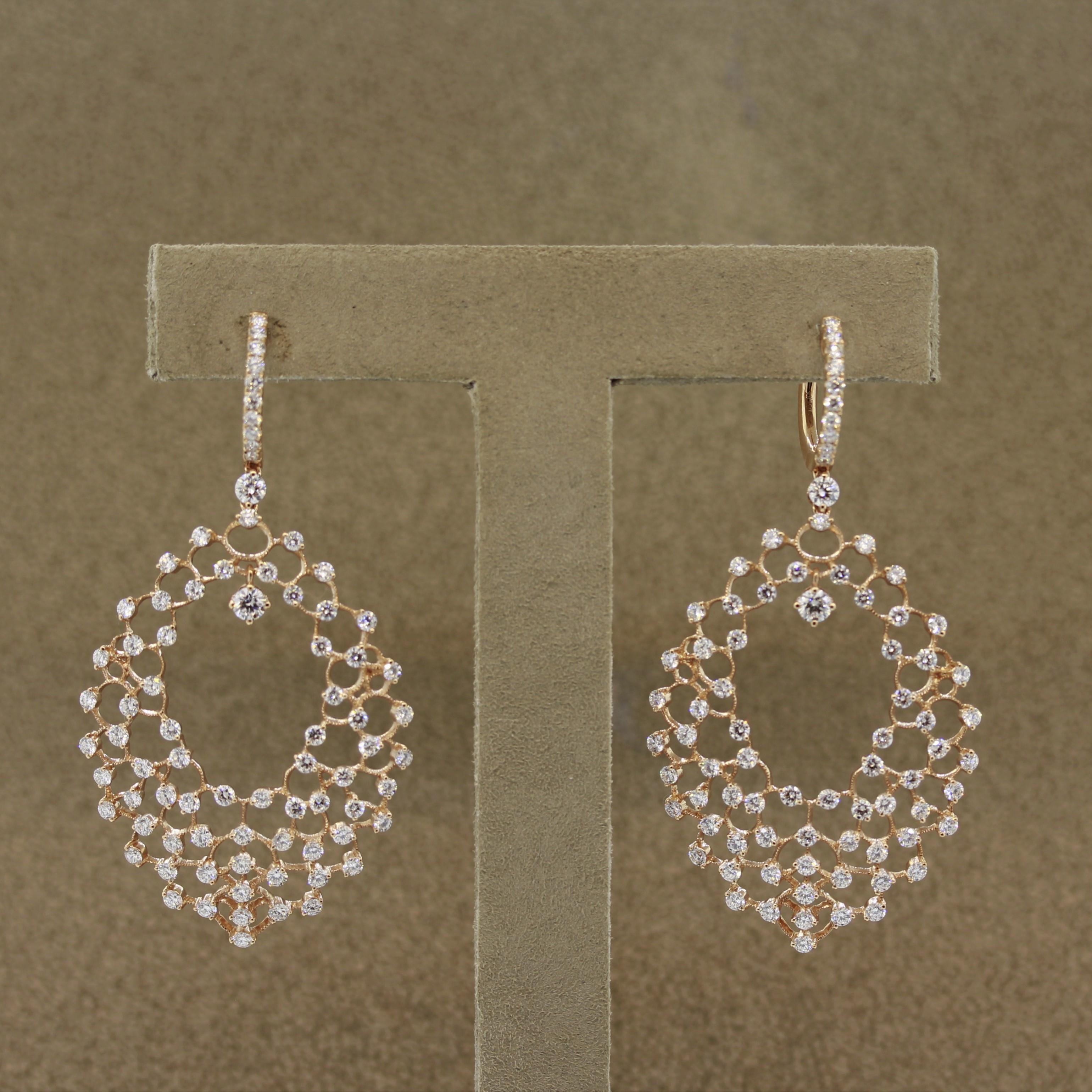 A web of diamonds! This fun yet chic pair of earrings feature 3.86 carats of round brilliant cut diamonds including a larger diamond which drops into the center of the earrings. Set in 18k rose gold, these will make a great addition to any outfit,